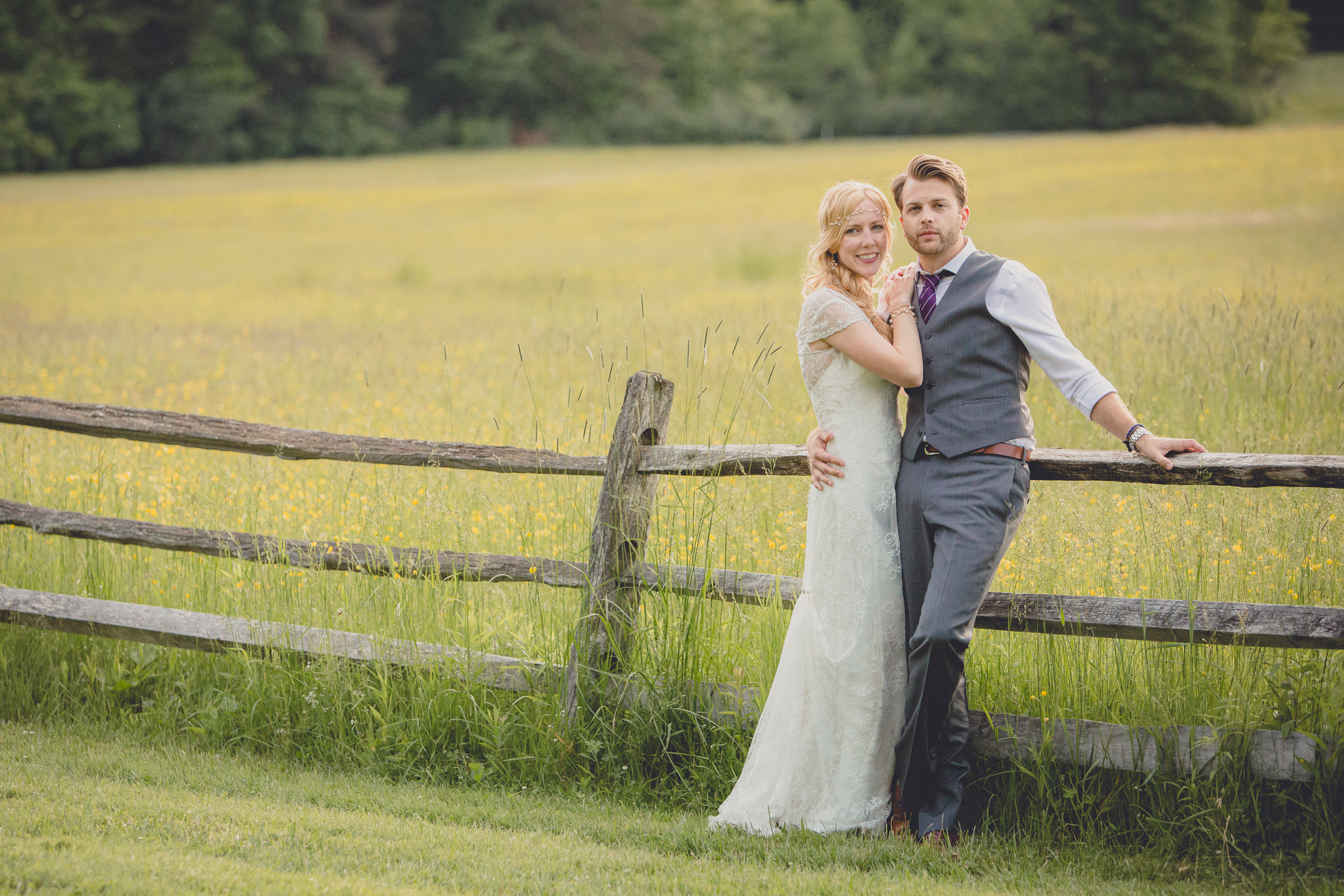 bride and groom pose for portraits in field during reception at small wedding venue Knox Farm in WNY