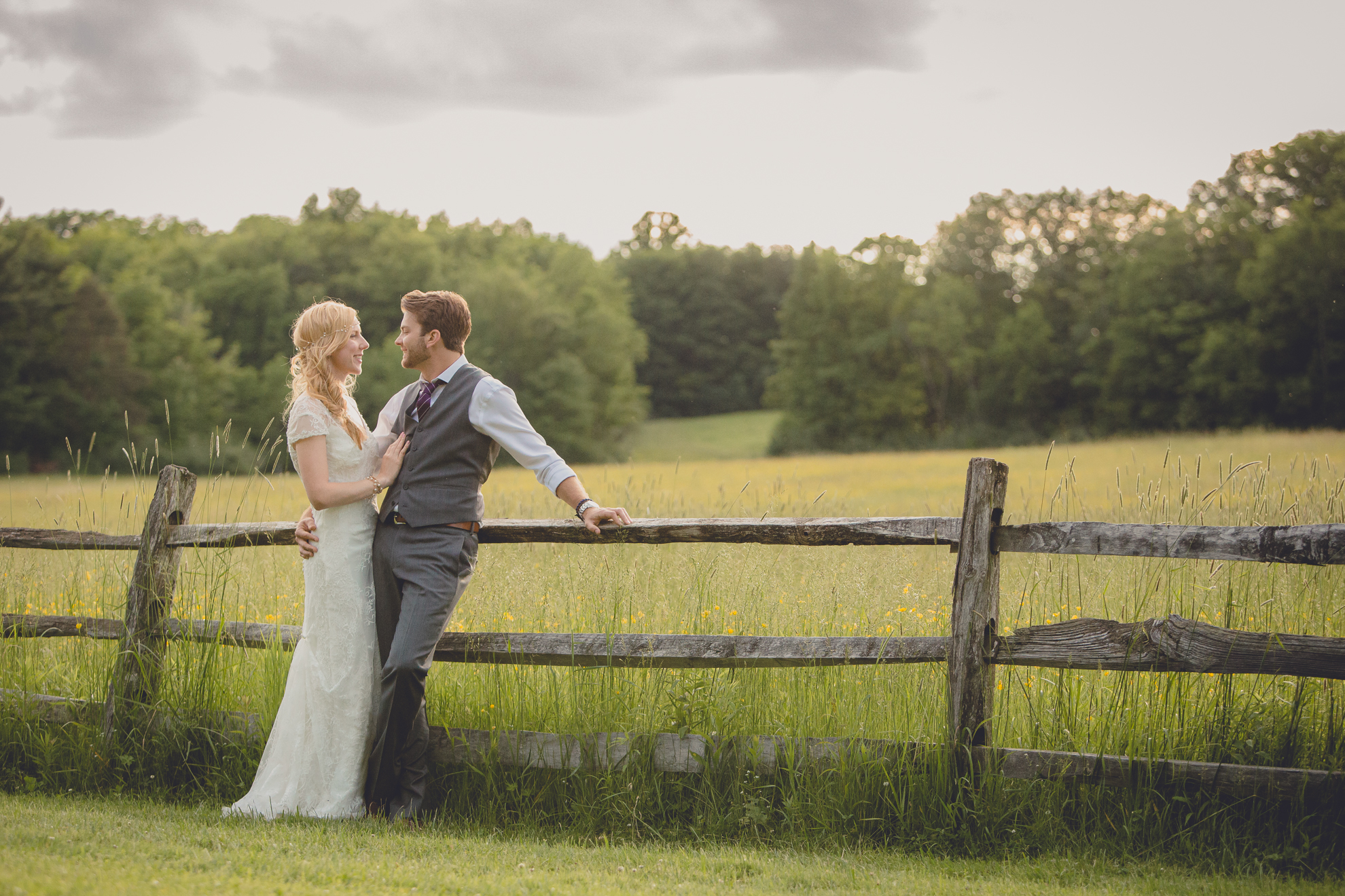 bride and groom pose for portraits in field during reception at small wedding venue Knox Farm in WNY