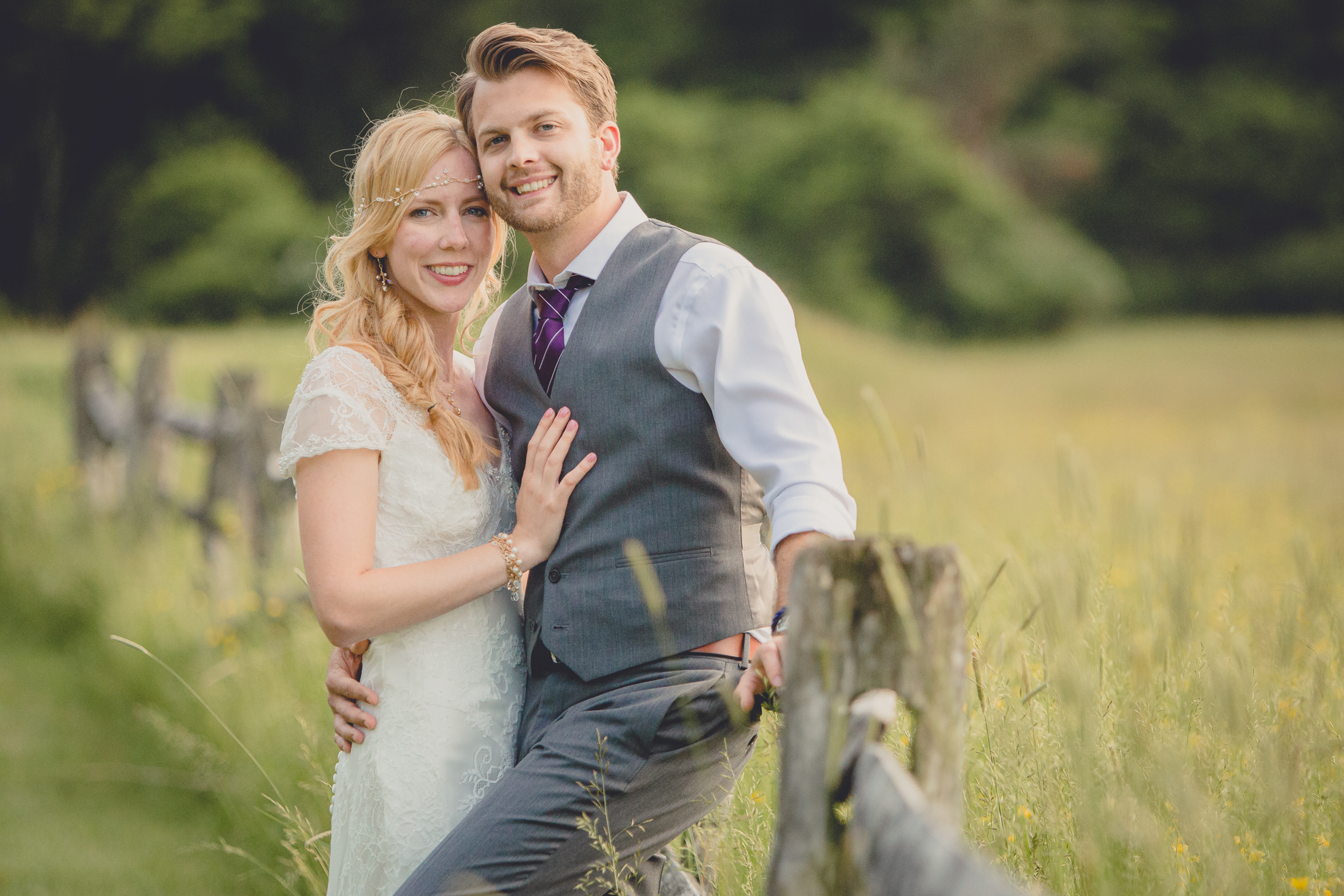 bride and groom pose for portraits in field during reception at small wedding venue Knox Farm in WNY
