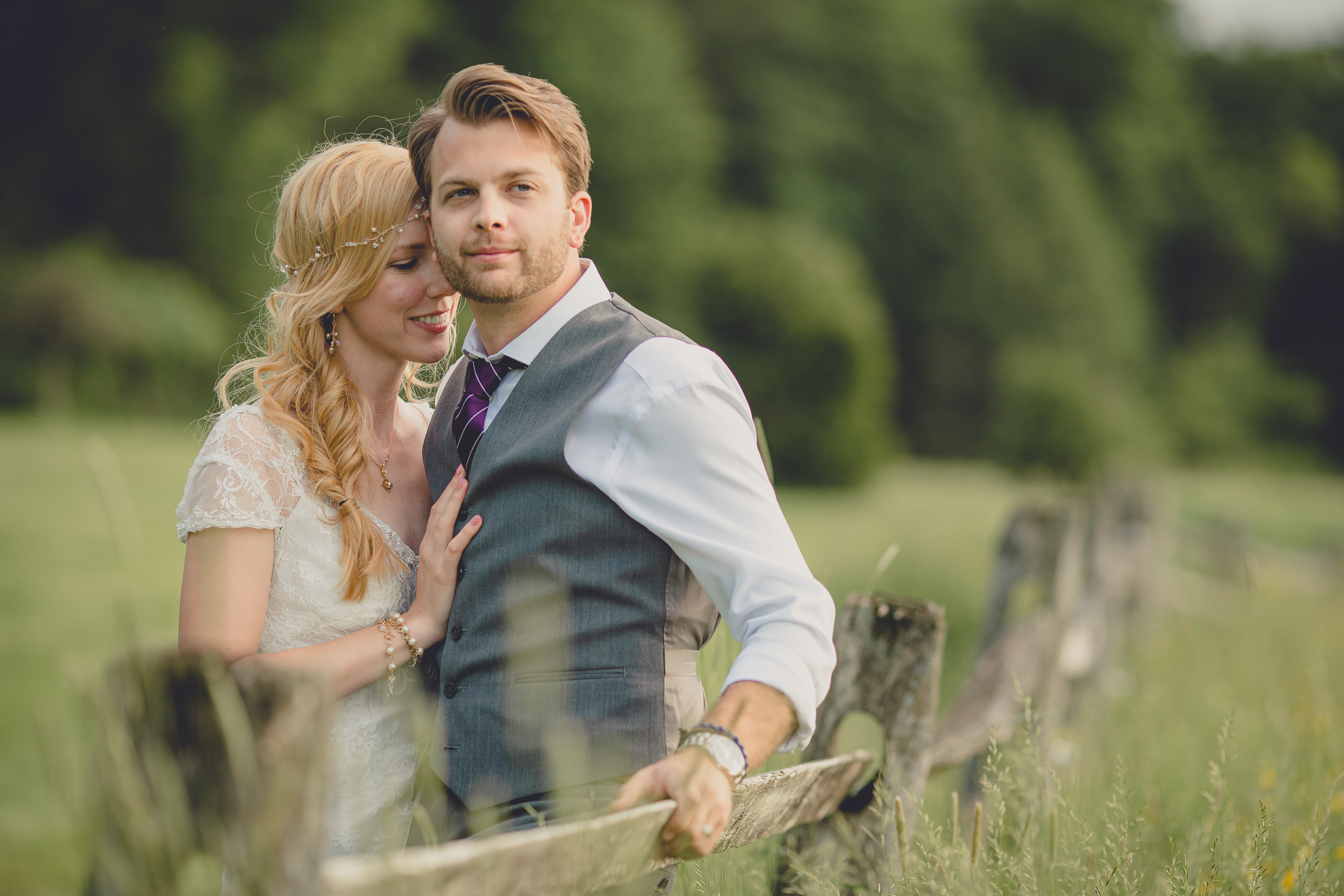 bride and groom pose for portraits in field during reception at small wedding venue Knox Farm in WNY