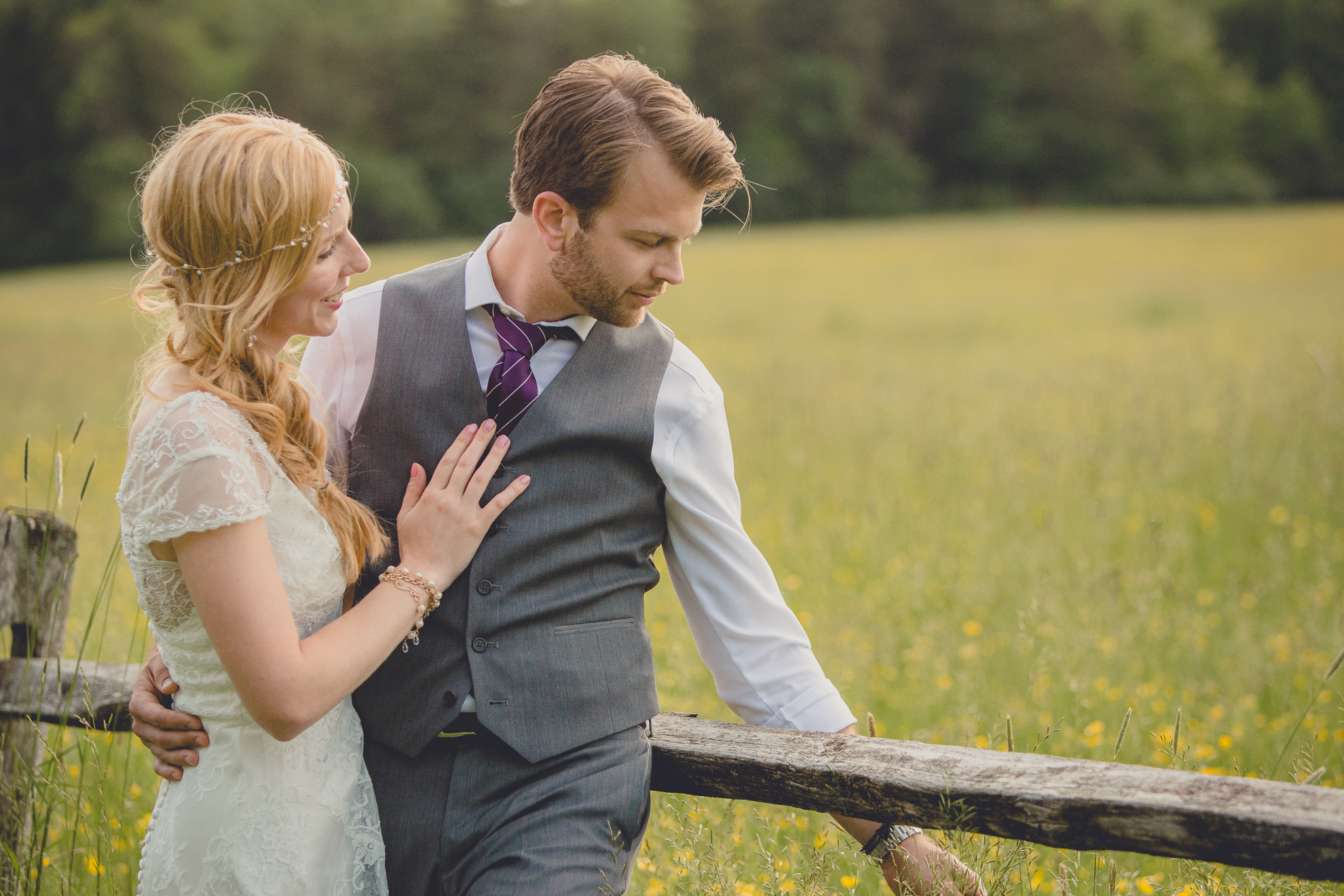 bride and groom pose for portraits in field during reception at small wedding venue Knox Farm in WNY
