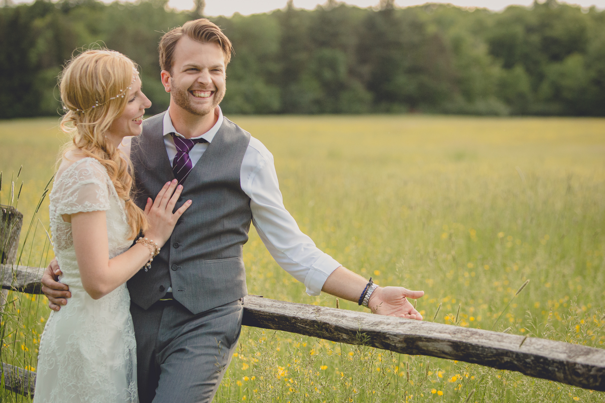 bride and groom pose for portraits in field during reception at small wedding venue Knox Farm in WNY