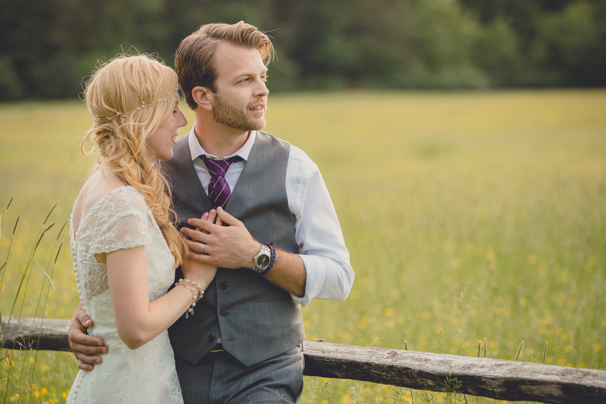 bride and groom pose for portraits in field during reception at small wedding venue Knox Farm in WNY
