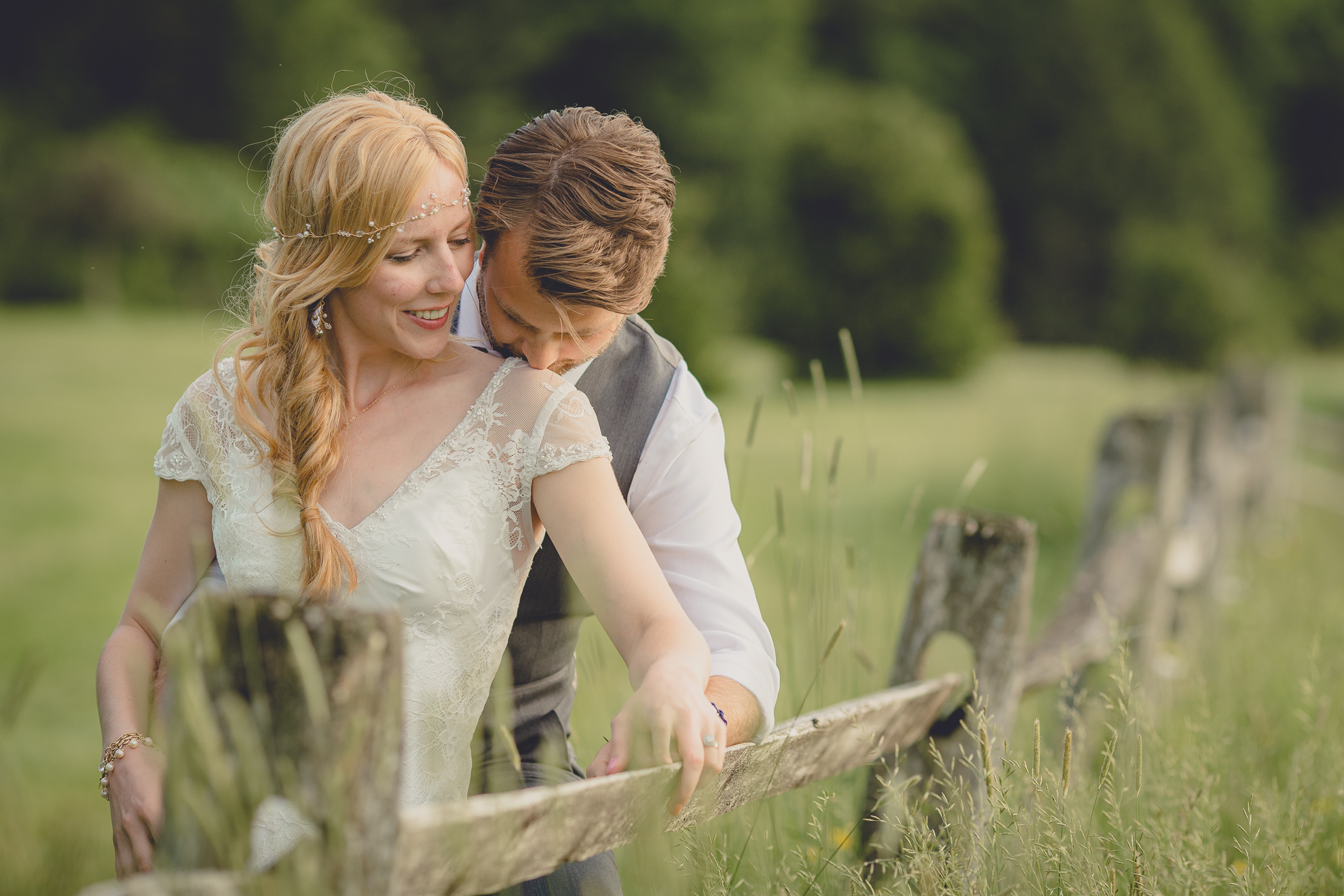 bride and groom pose for portraits in field during reception at small wedding venue Knox Farm in WNY