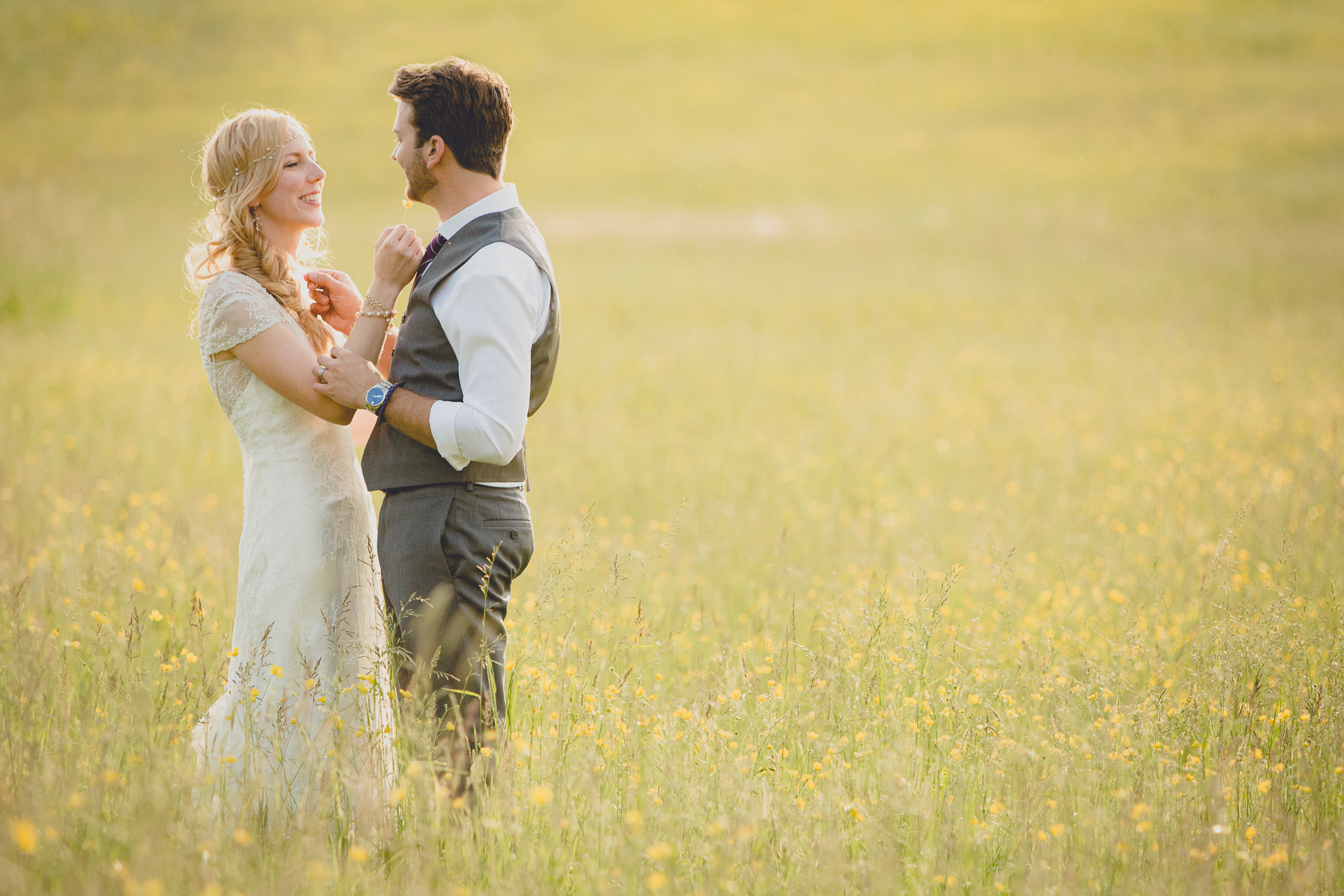 bride and groom pose for portraits in field during reception at small wedding venue Knox Farm in WNY