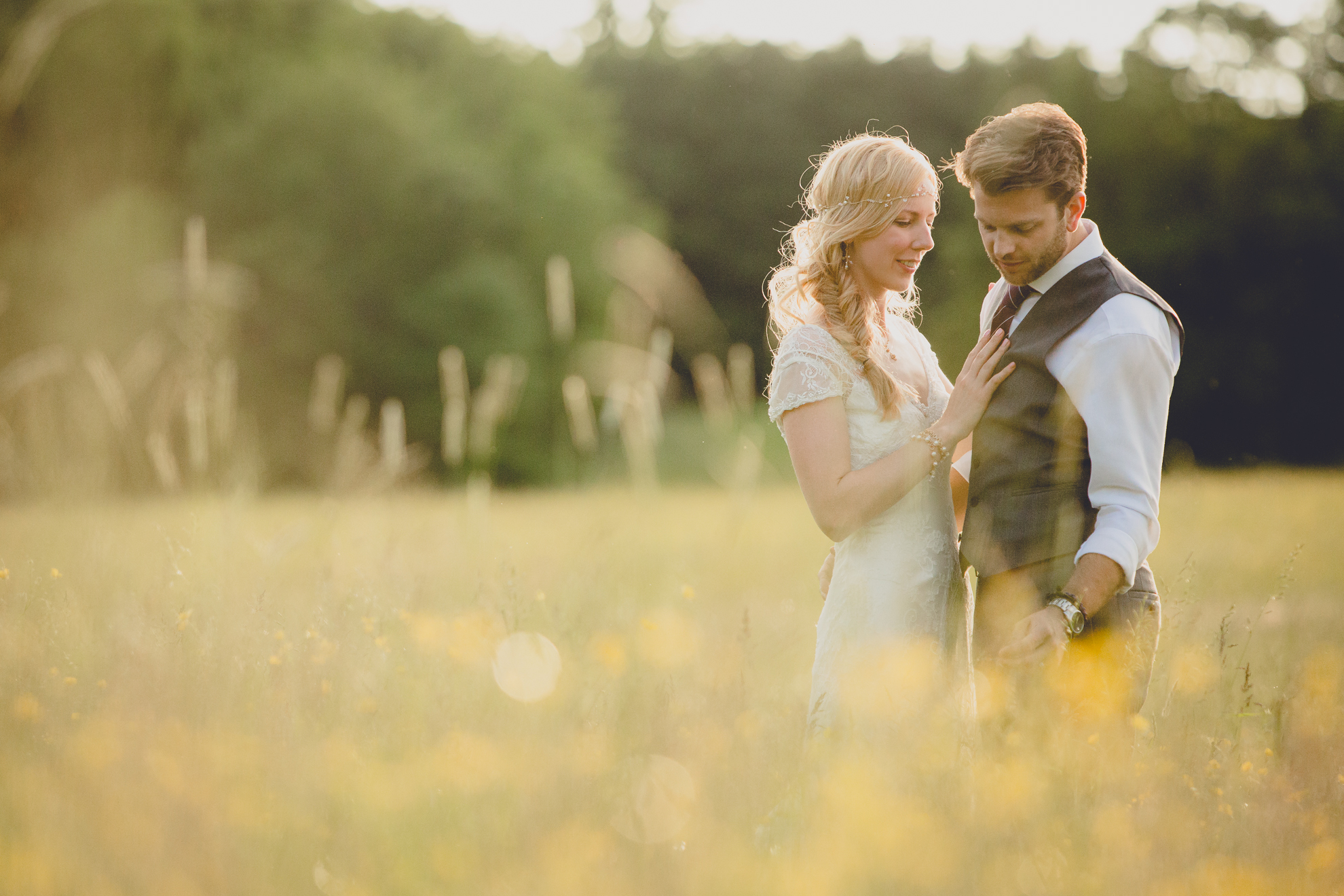 bride and groom pose for portraits in field during reception at small wedding venue Knox Farm in WNY