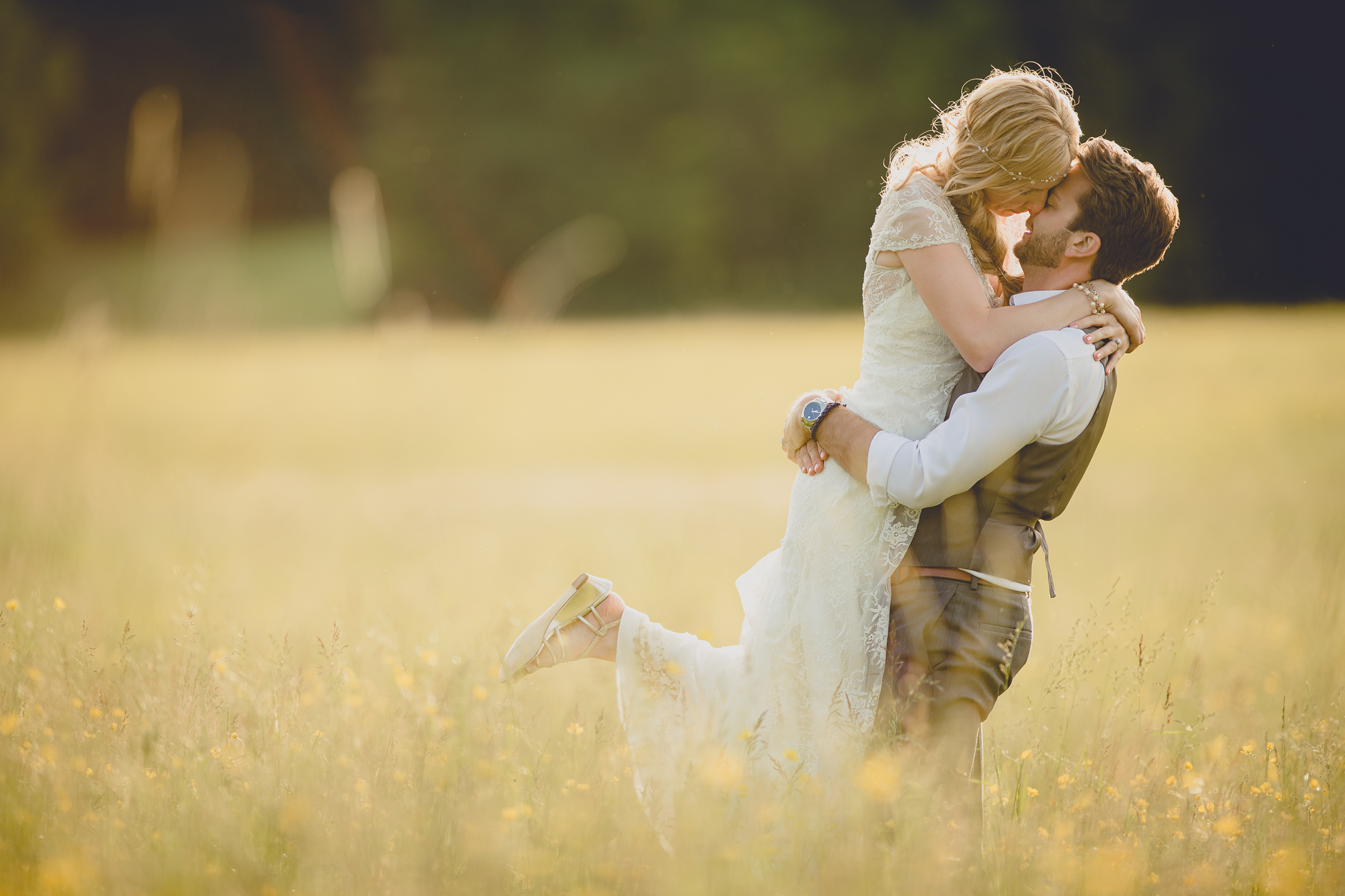 bride and groom pose for portraits in field during reception at small wedding venue Knox Farm in WNY