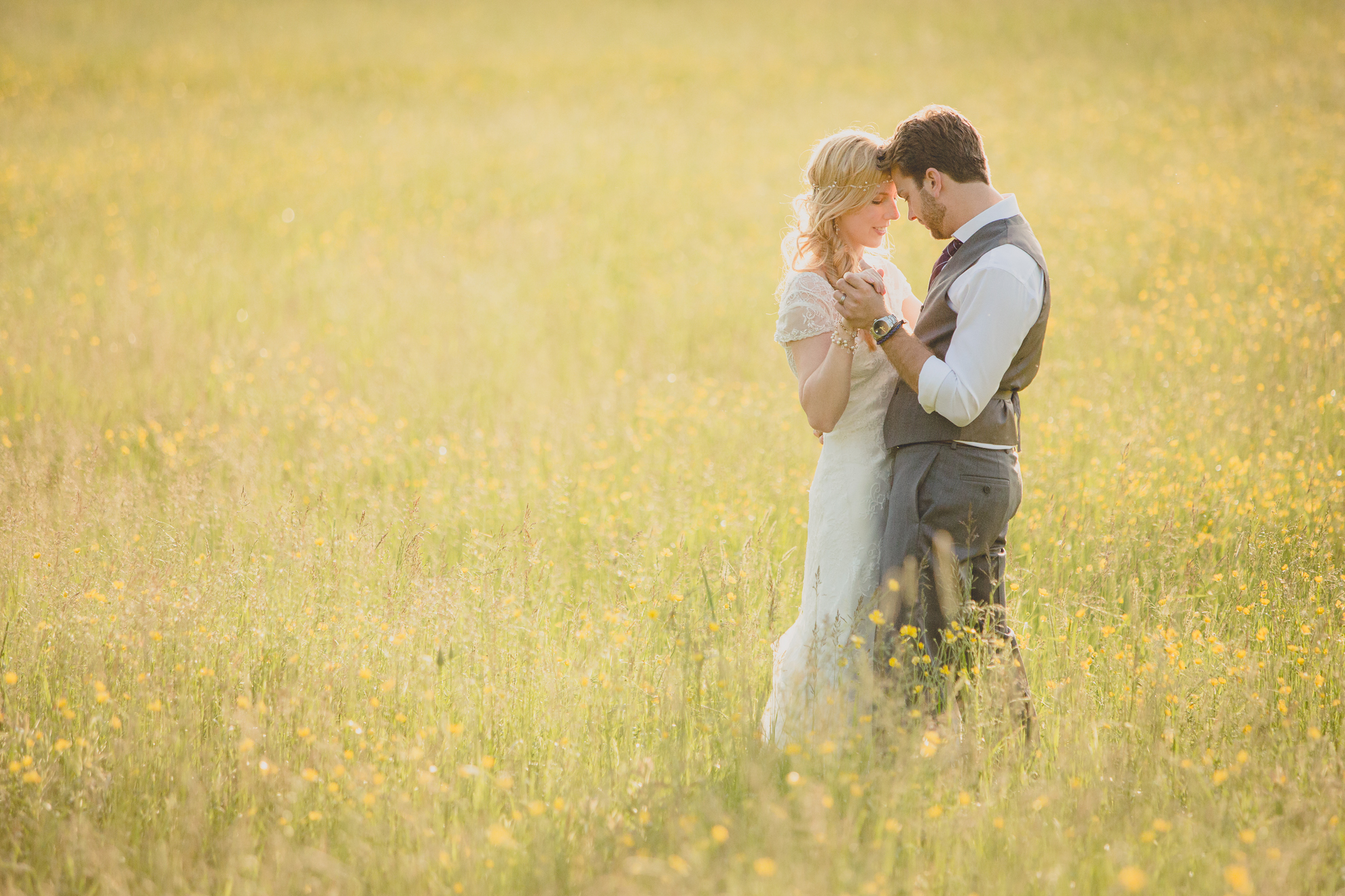 bride and groom pose for portraits in field during reception at small wedding venue Knox Farm in WNY