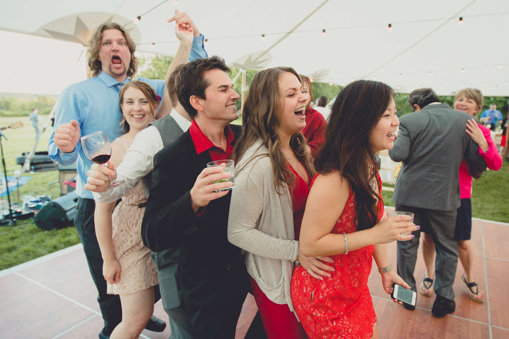 guests dance during tented reception at small wedding venue Knox Farm near Buffalo, NY