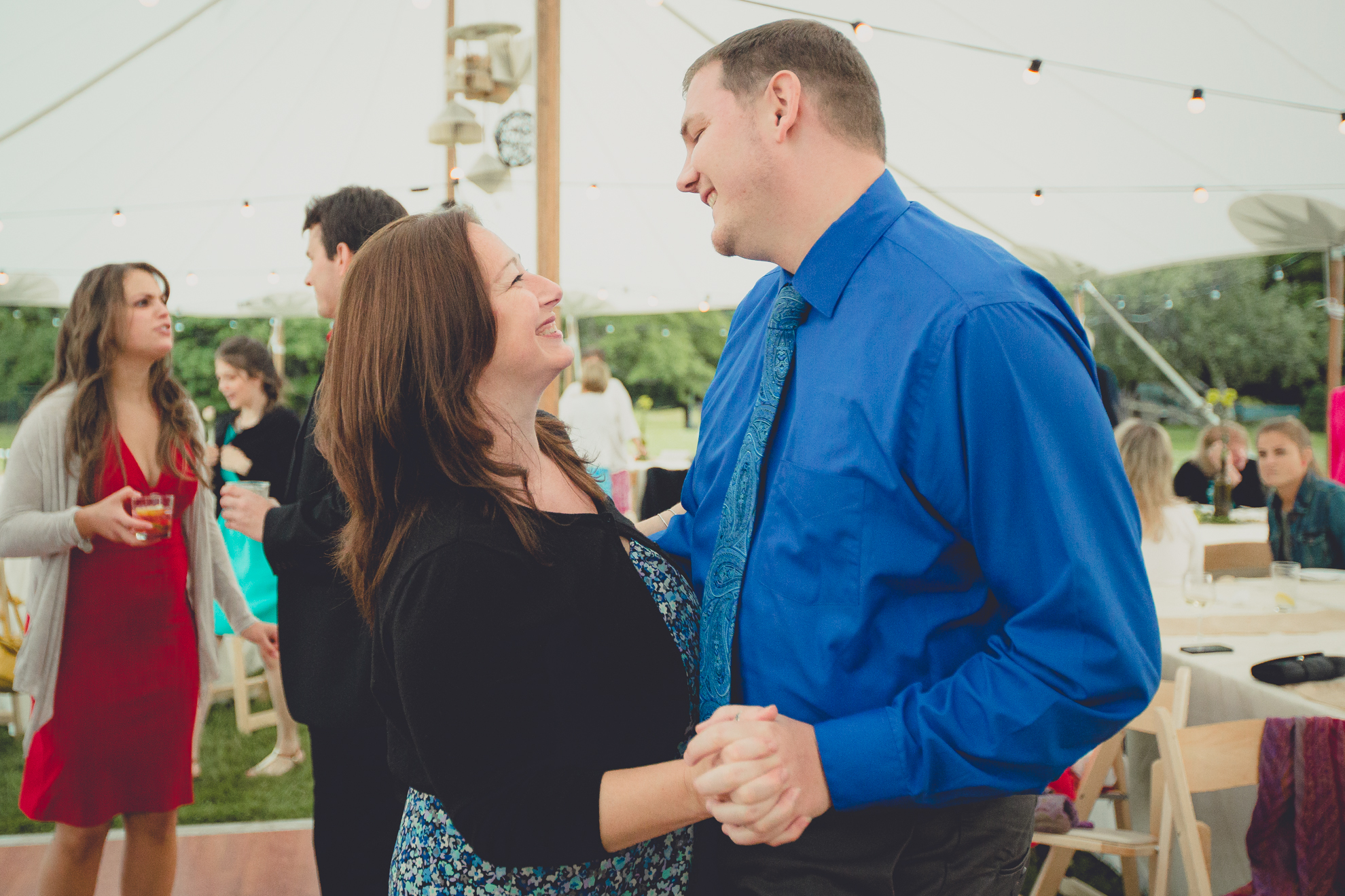 guests dance during tented reception at small wedding venue Knox Farm near Buffalo, NY