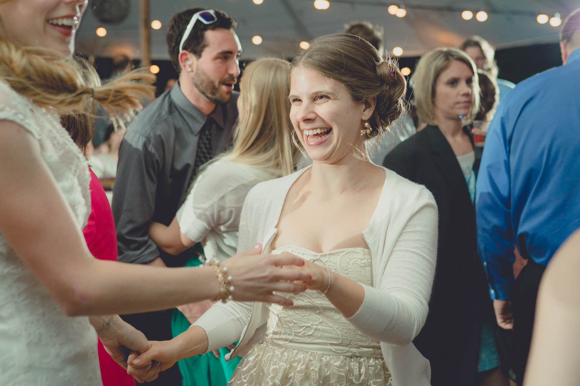 guests dance during tented reception at small wedding venue Knox Farm near Buffalo, NY