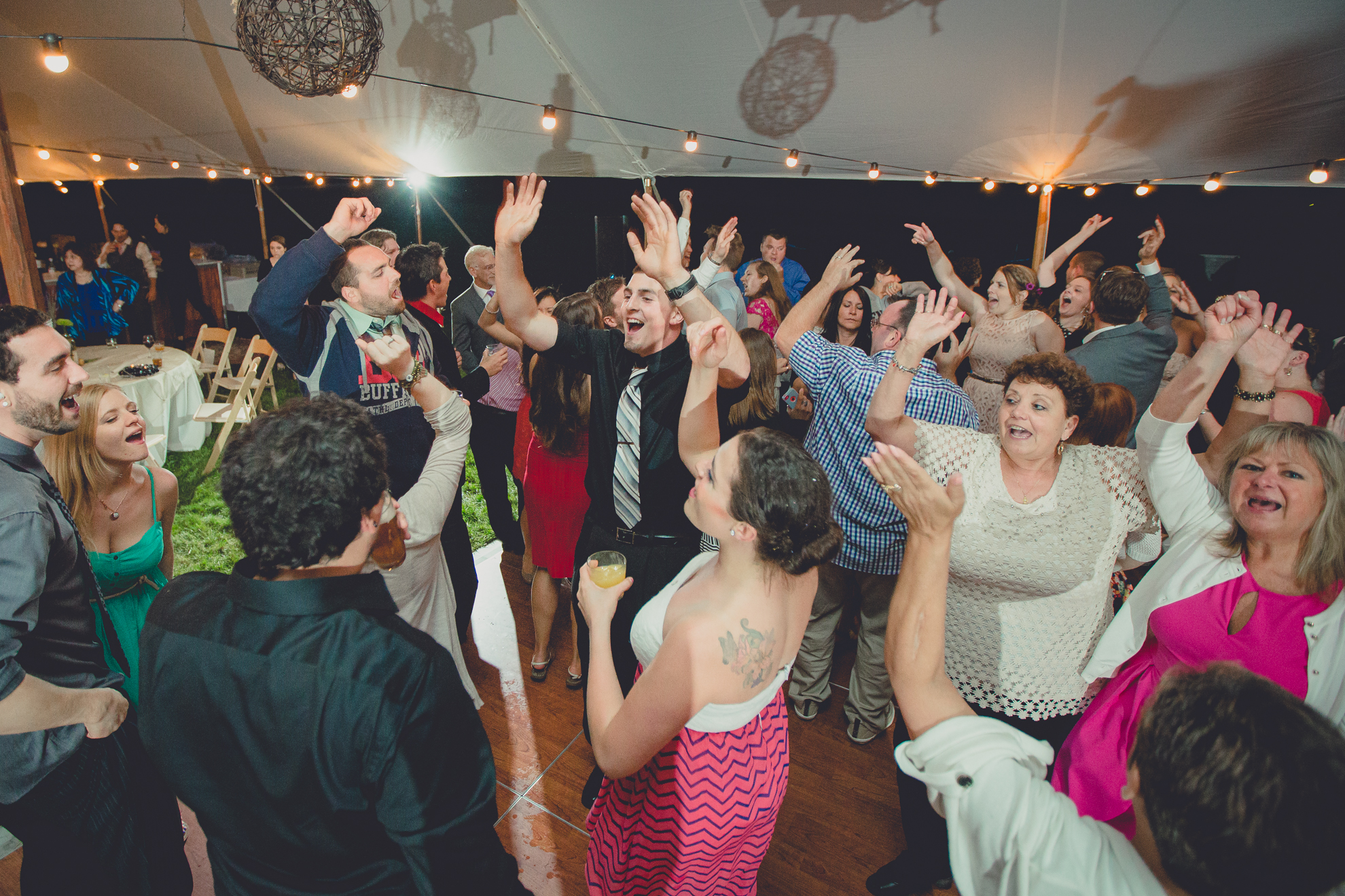 guests dance during tented reception at small wedding venue Knox Farm near Buffalo, NY