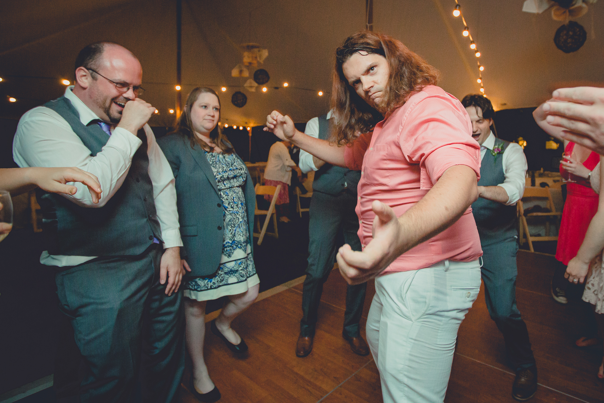 guests dance during tented reception at small wedding venue Knox Farm near Buffalo, NY