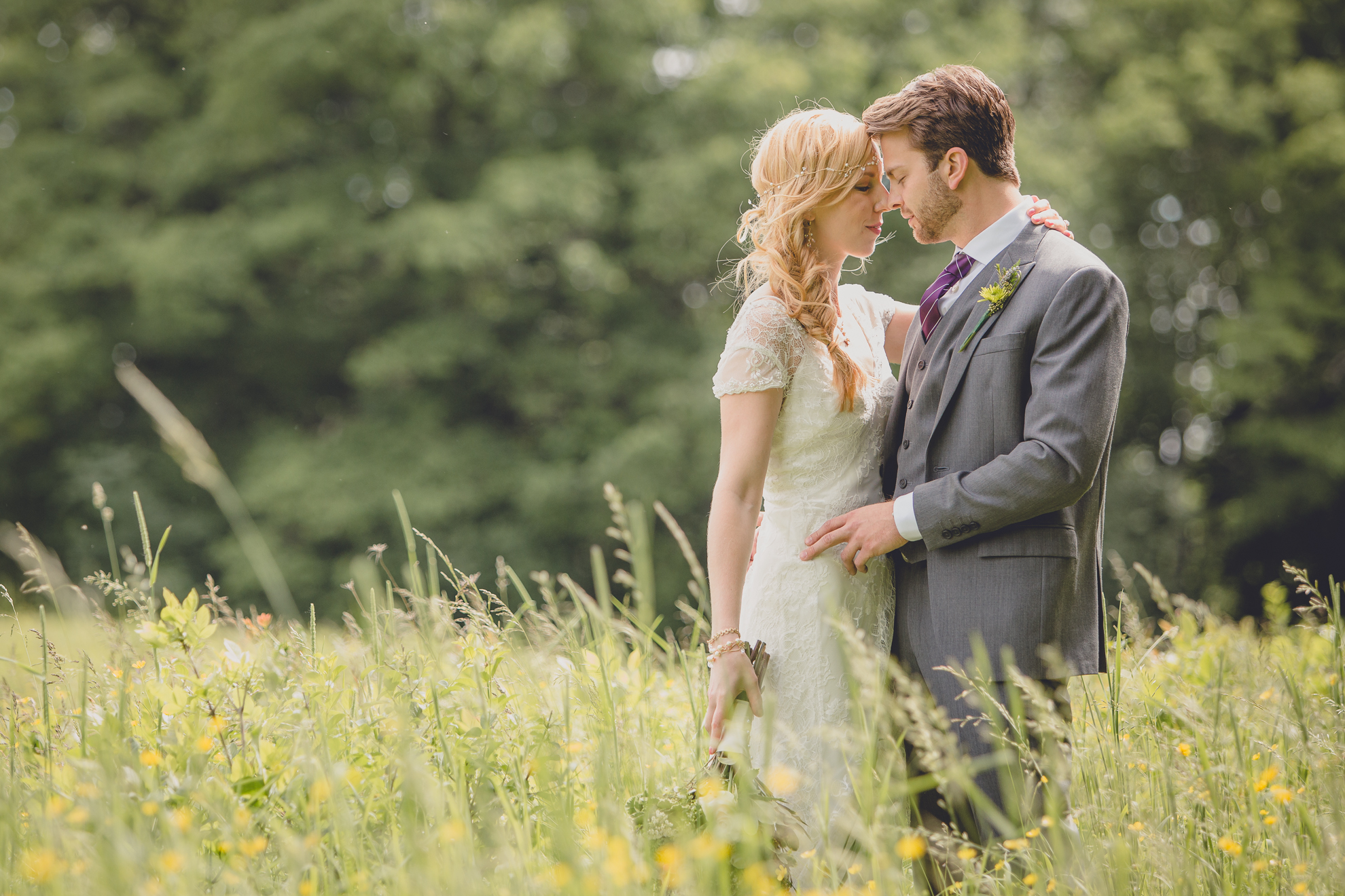 bride and groom pose for portraits in field at small wedding at Knox Farm near Buffalo, NY