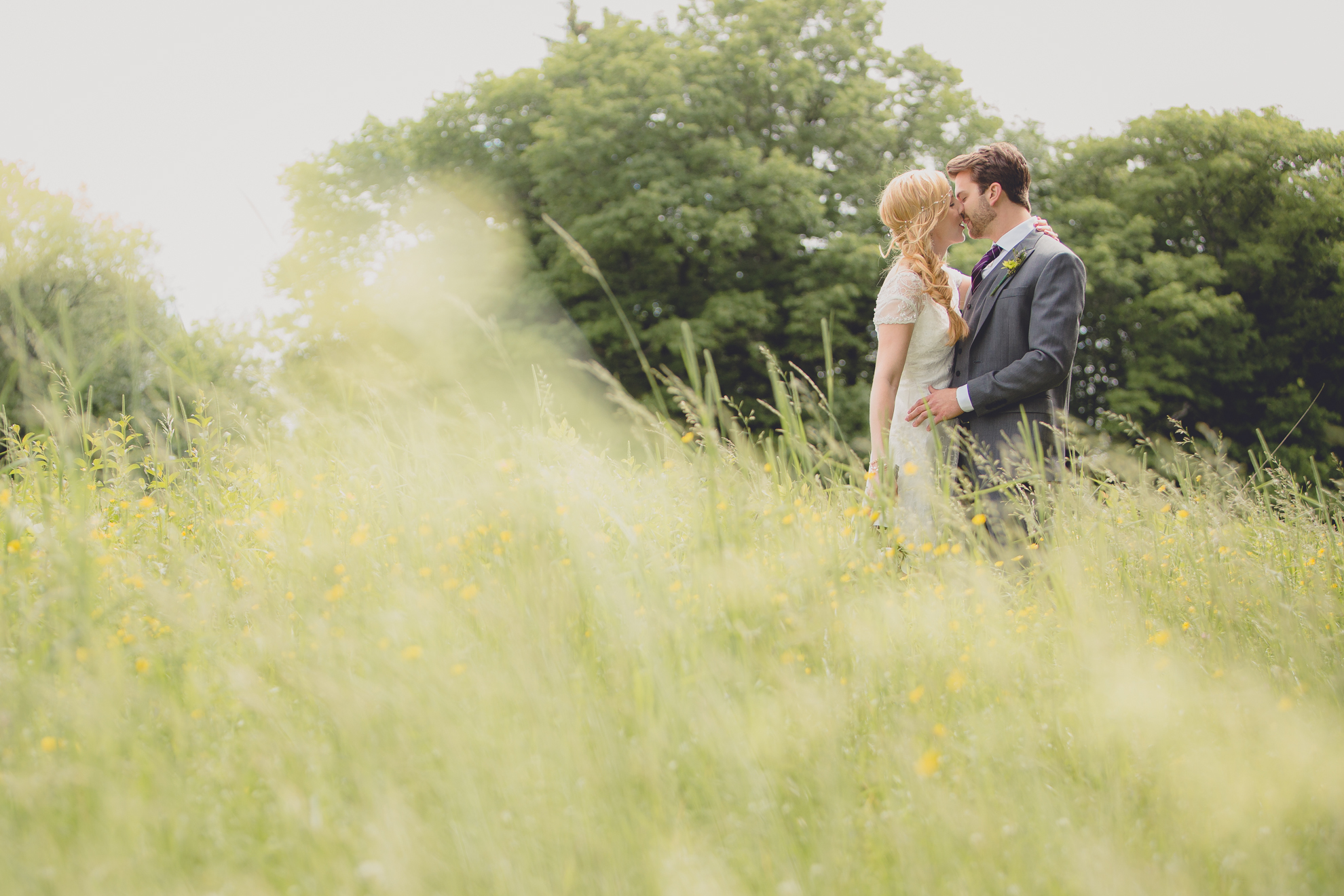bride and groom pose for portraits in field at small wedding at Knox Farm near Buffalo, NY