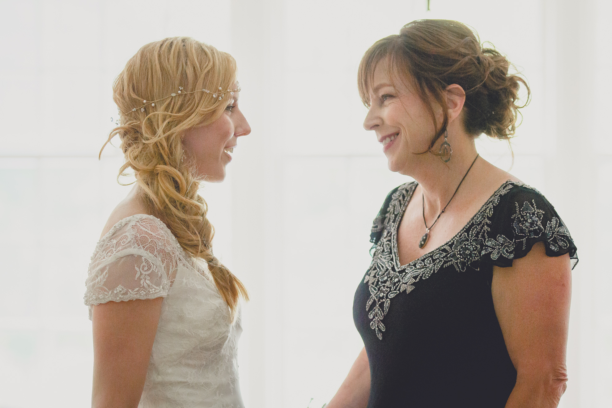 bride and mom look at each other in mansion on property before ceremony at small wedding at Knox Farm near Buffalo, NY