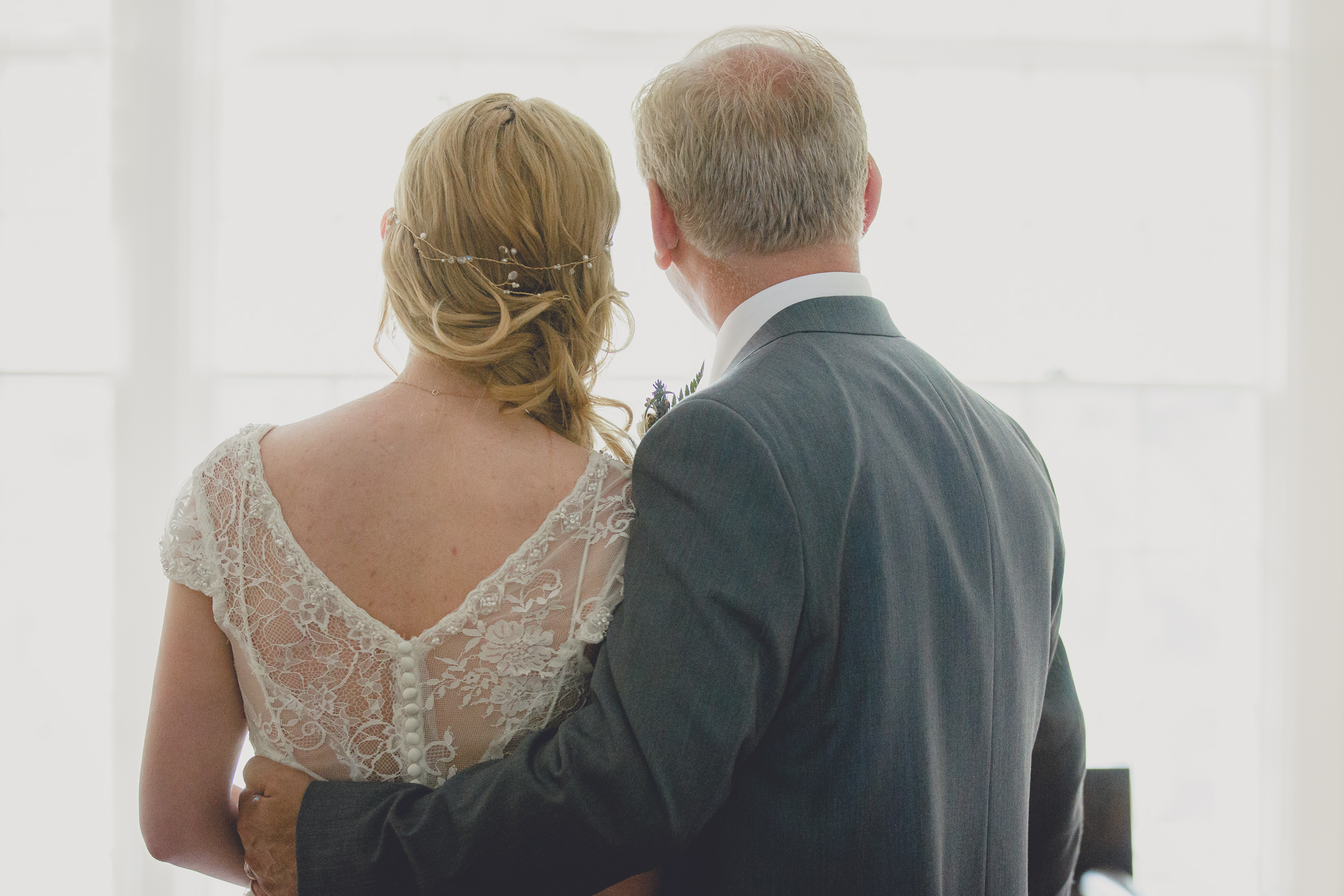bride and dad look out window of house before ceremony at small wedding at Knox Farm near Buffalo, NY