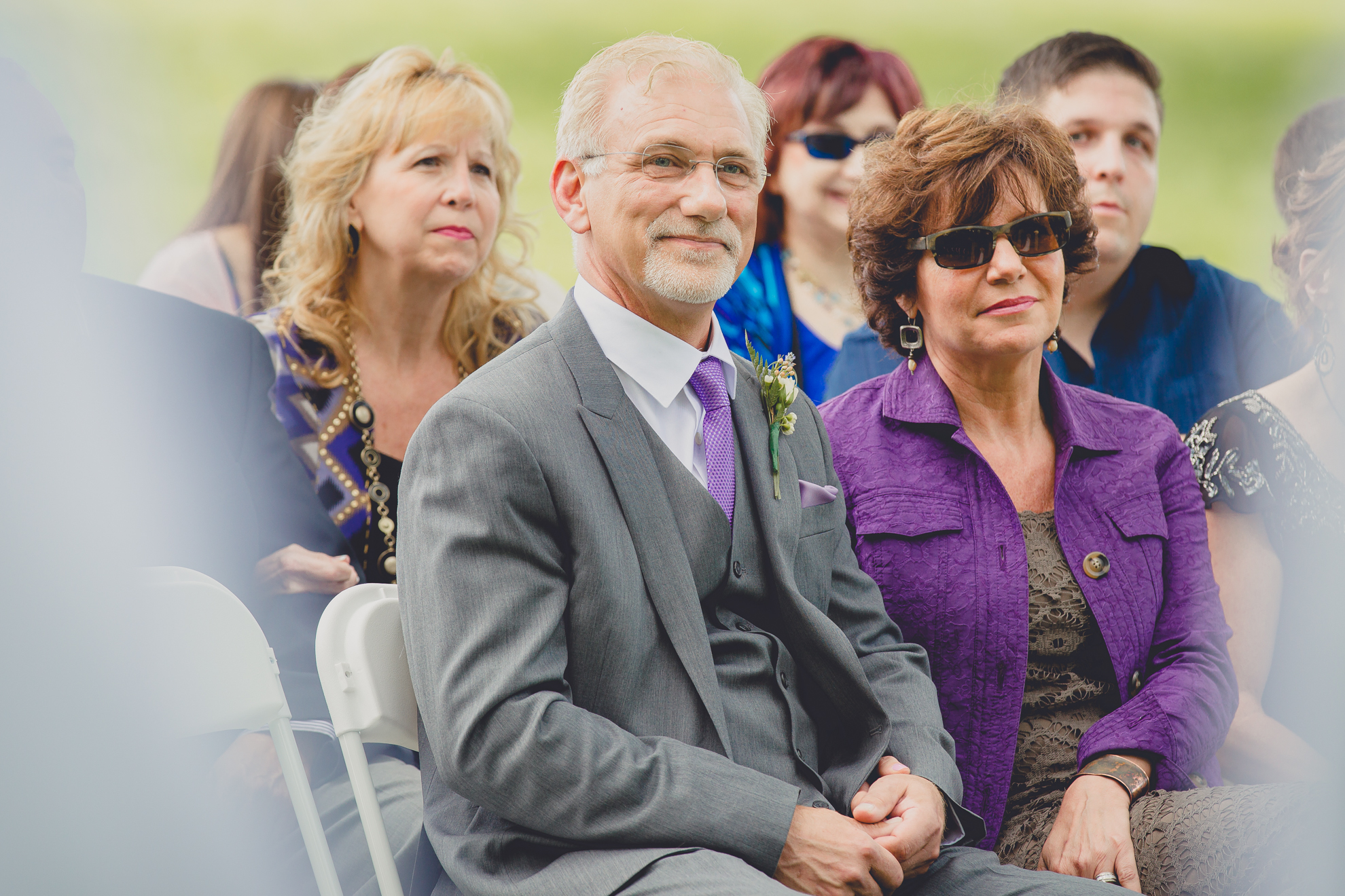 parents smile at bride and groom during ceremony at small wedding at Knox Farm near Buffalo, NY