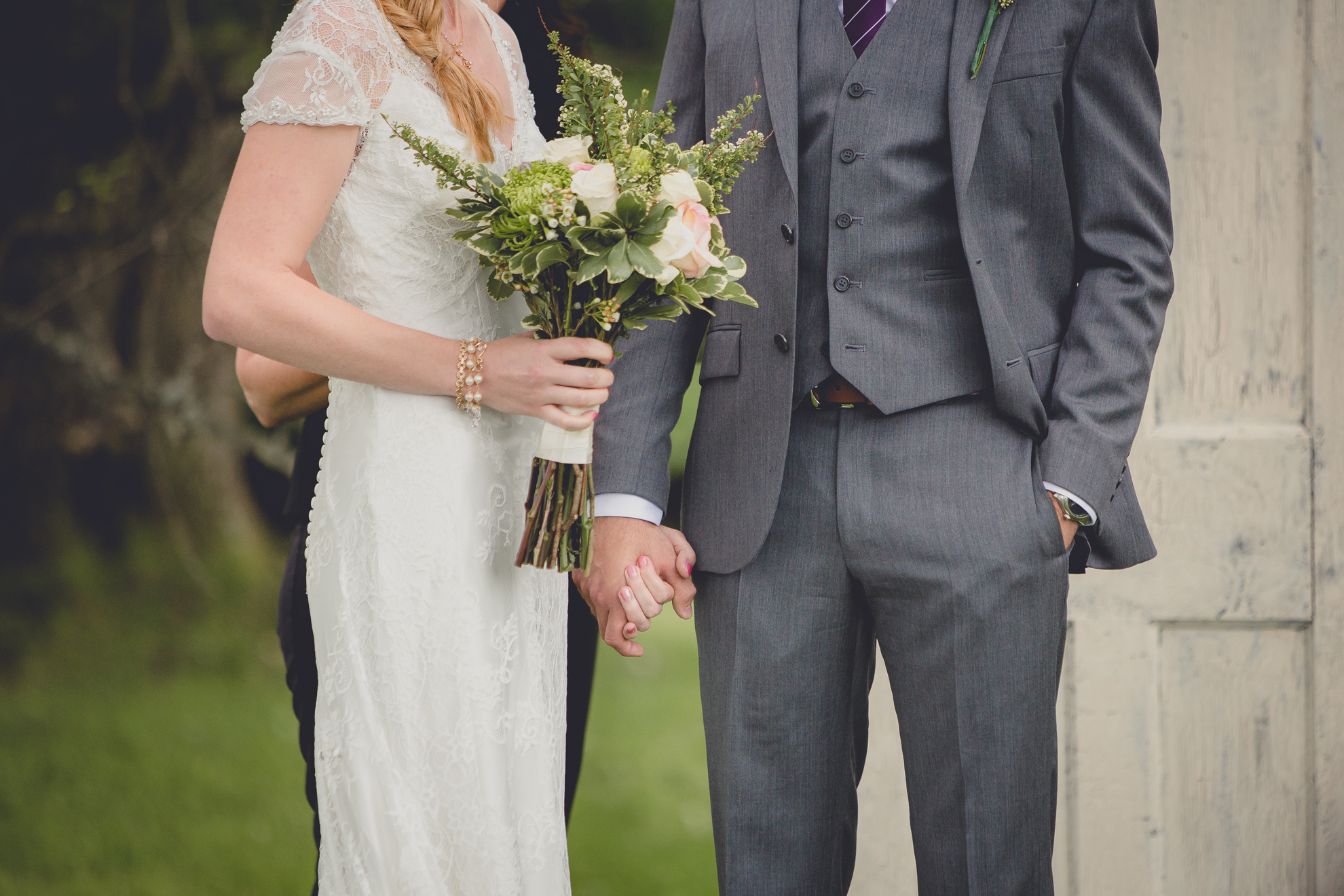 bride and groom hold hands during ceremony at small wedding at Knox Farm near Buffalo, NY