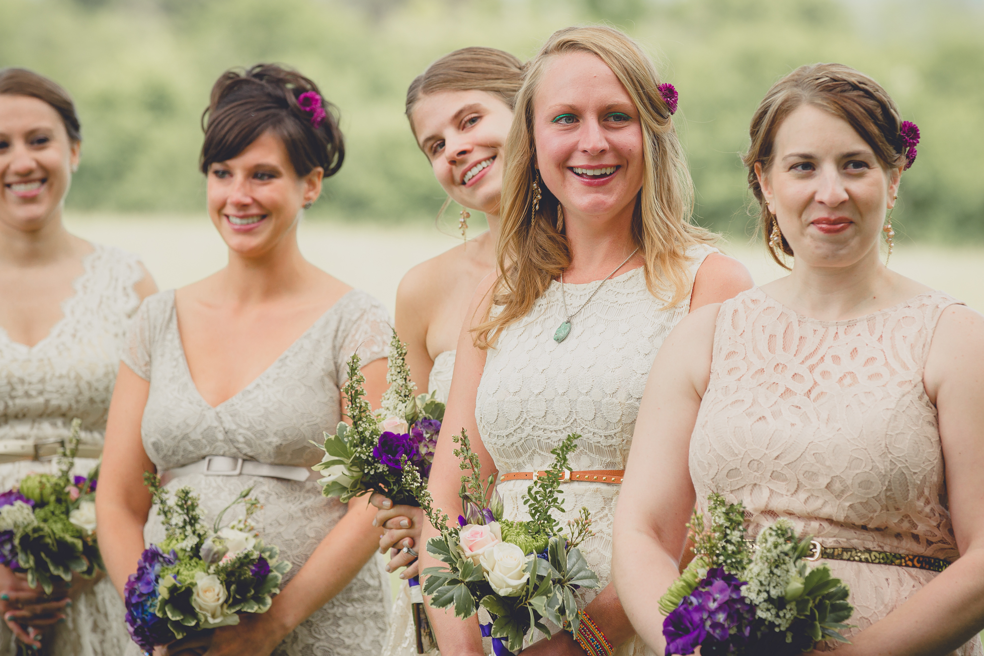 bridesmaids laugh during ceremony at small wedding at Knox Farm near Buffalo, NY