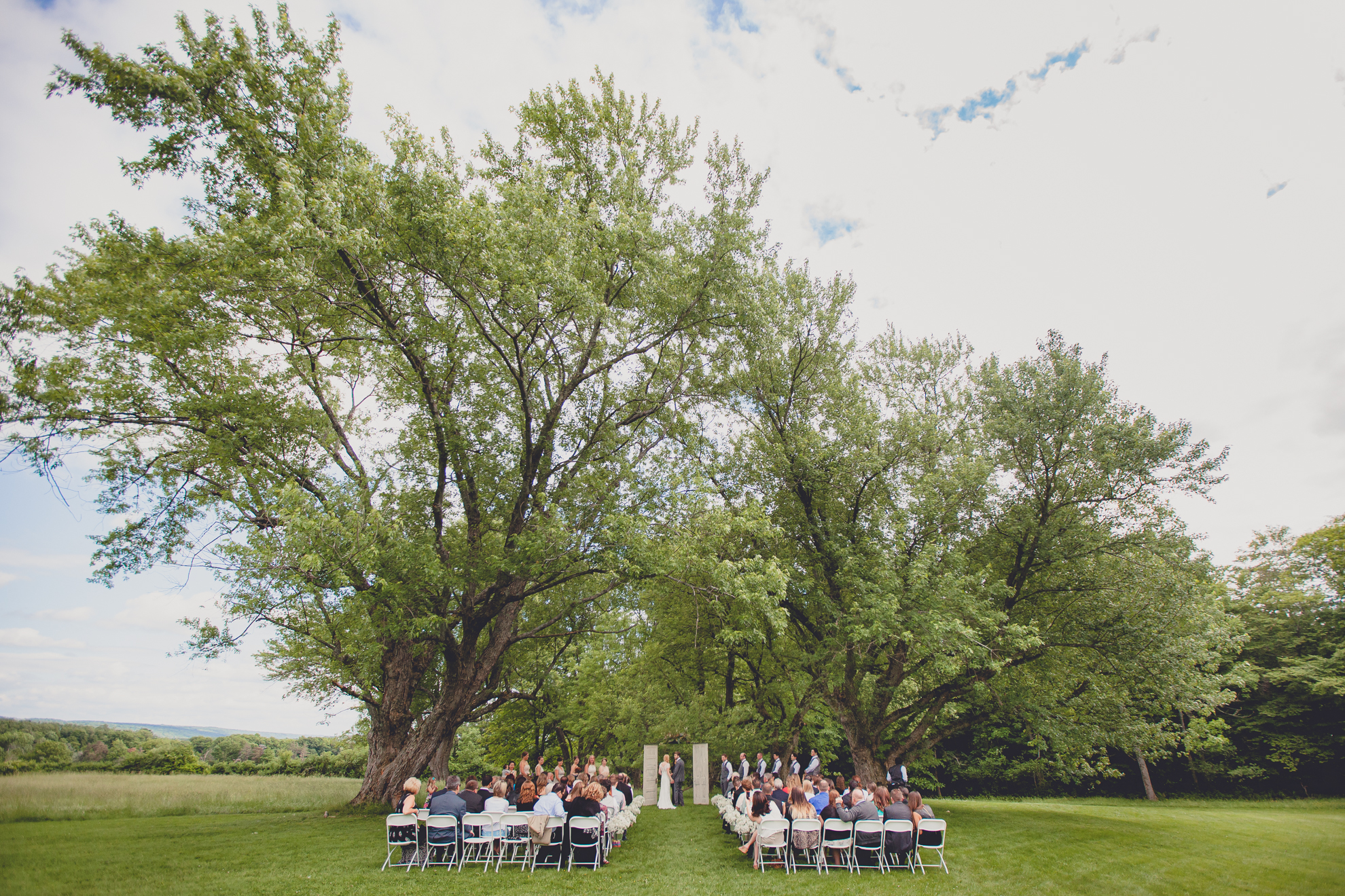 wedding ceremony location under trees in field at wedding at Knox Farm near Buffalo, NY
