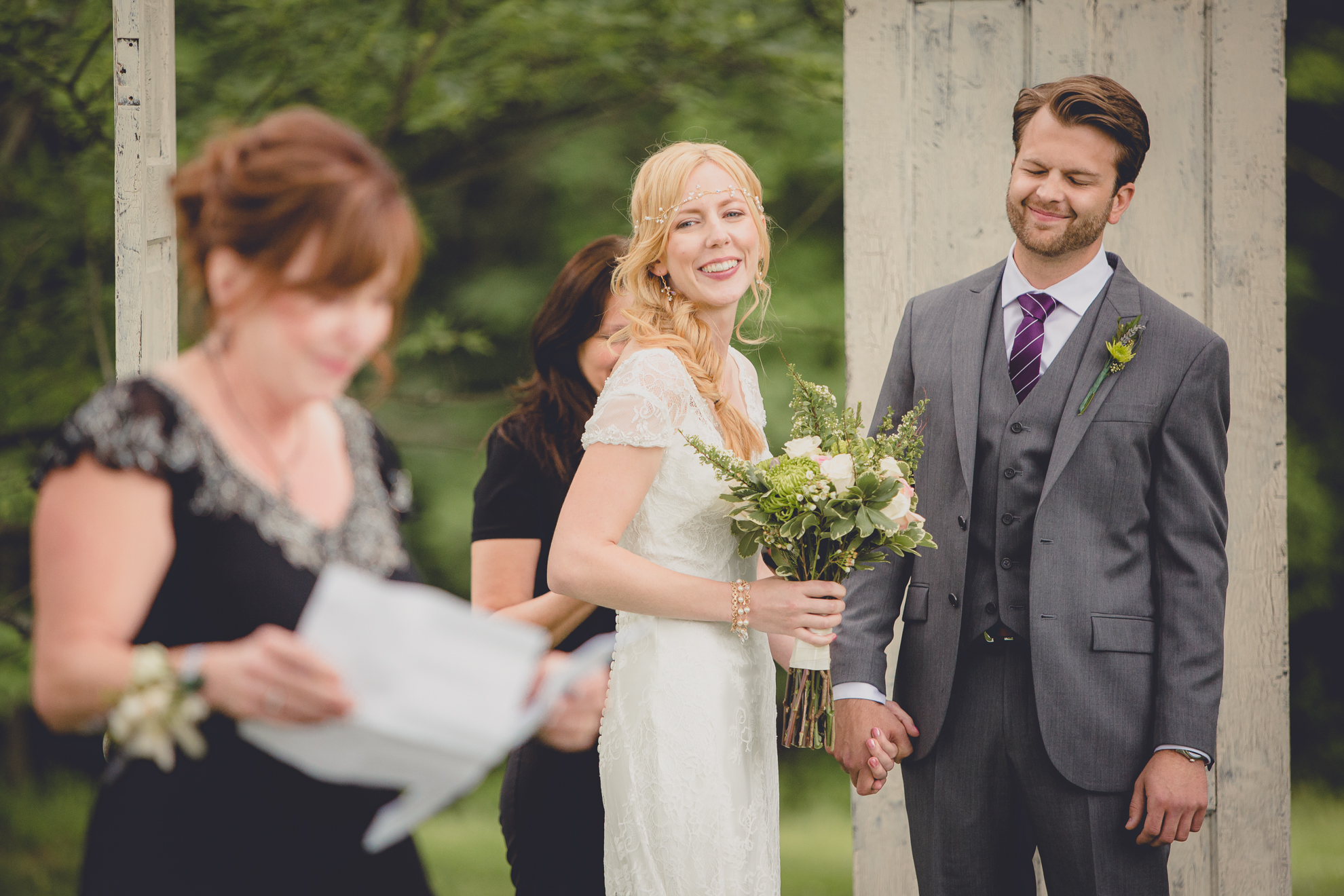 bride and groom laugh during ceremony at small wedding at Knox Farm near Buffalo, NY