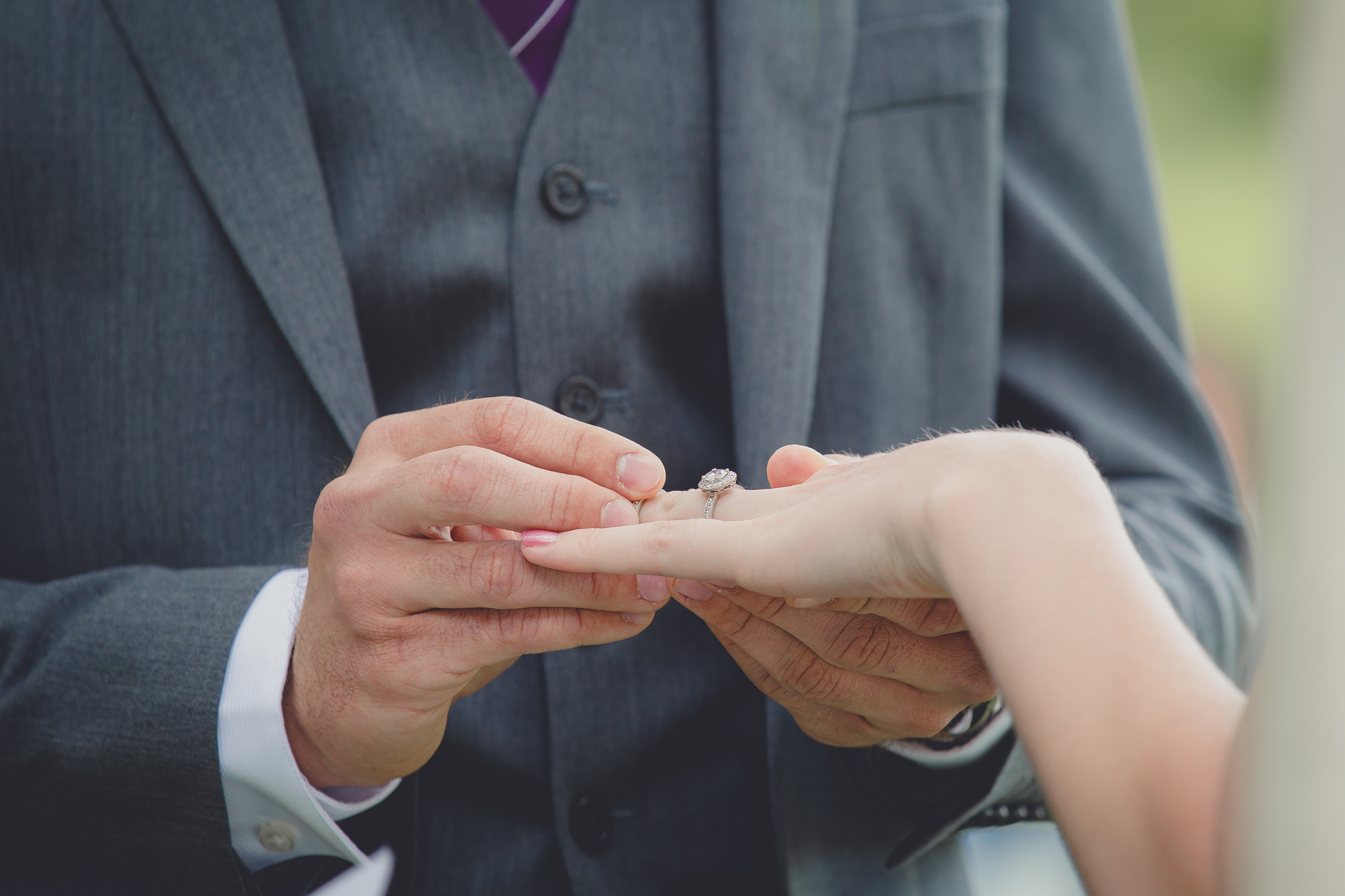 groom places ring on brides finger during ceremony at small wedding at Knox Farm near Buffalo, NY