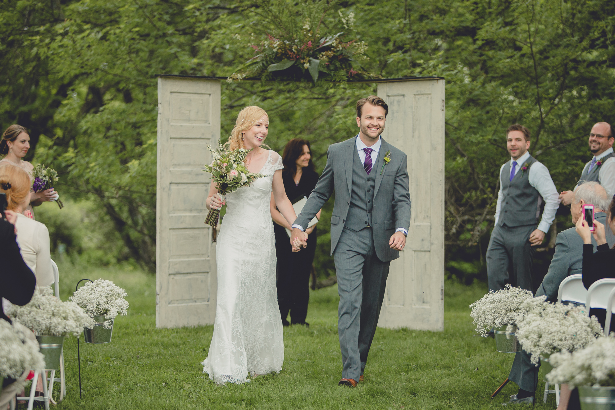 bride and groom walk up aisle during ceremony at small wedding at Knox Farm near Buffalo, NY