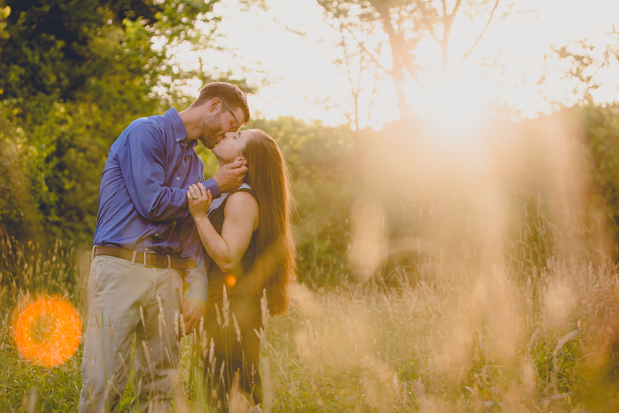 bride and groom kiss in field during wedding engagement photography at Knox Farm State Park near Buffalo, NY