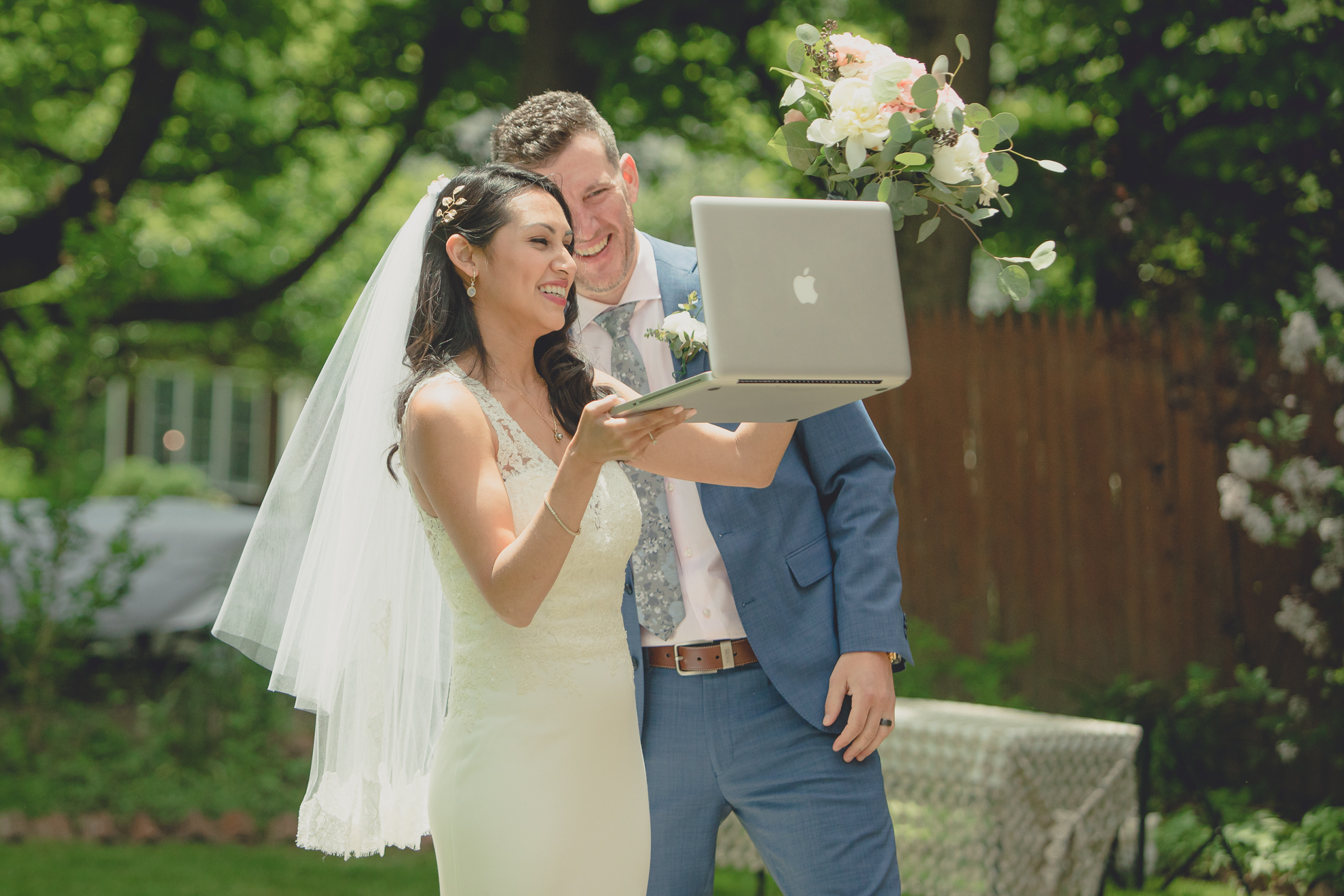 bride and groom talk to guests on zoom video call after small backyard micro wedding in Buffalo, NY