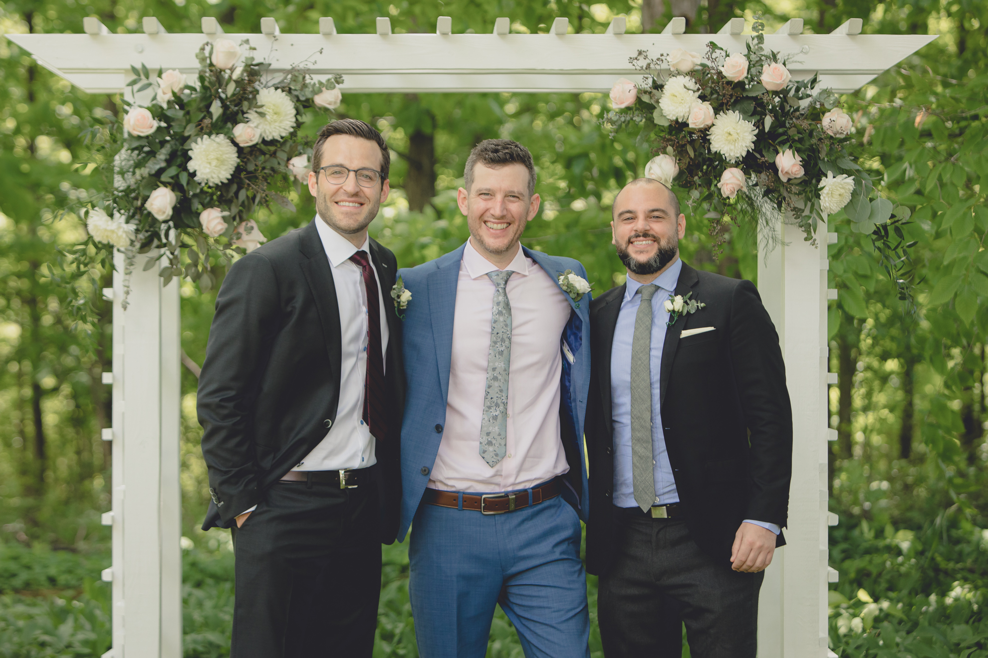 groomsmen smile for photographer after small backyard micro wedding ceremony in Buffalo, NY