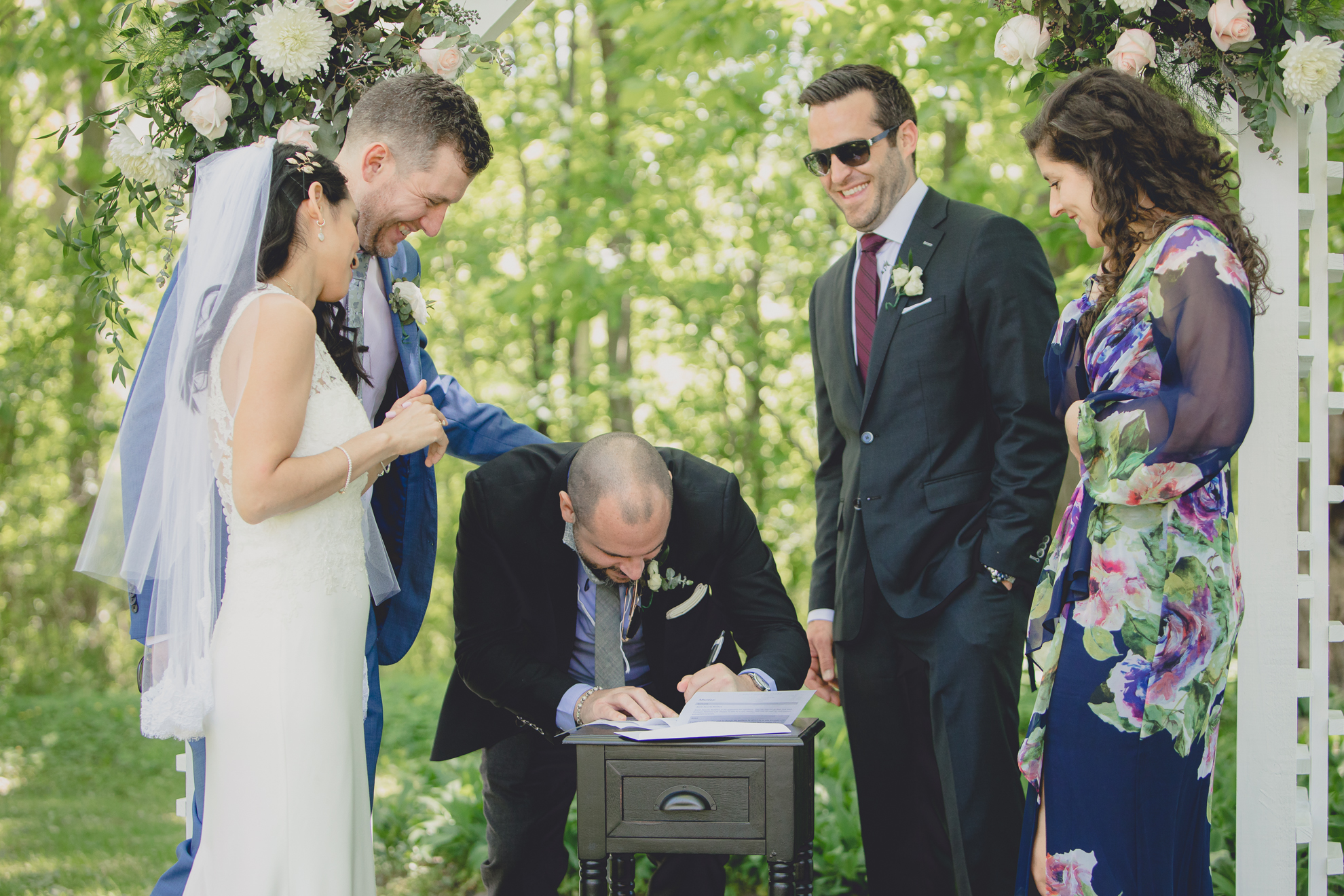 witnesses sign wedding license after small backyard micro wedding ceremony in Buffalo, NY