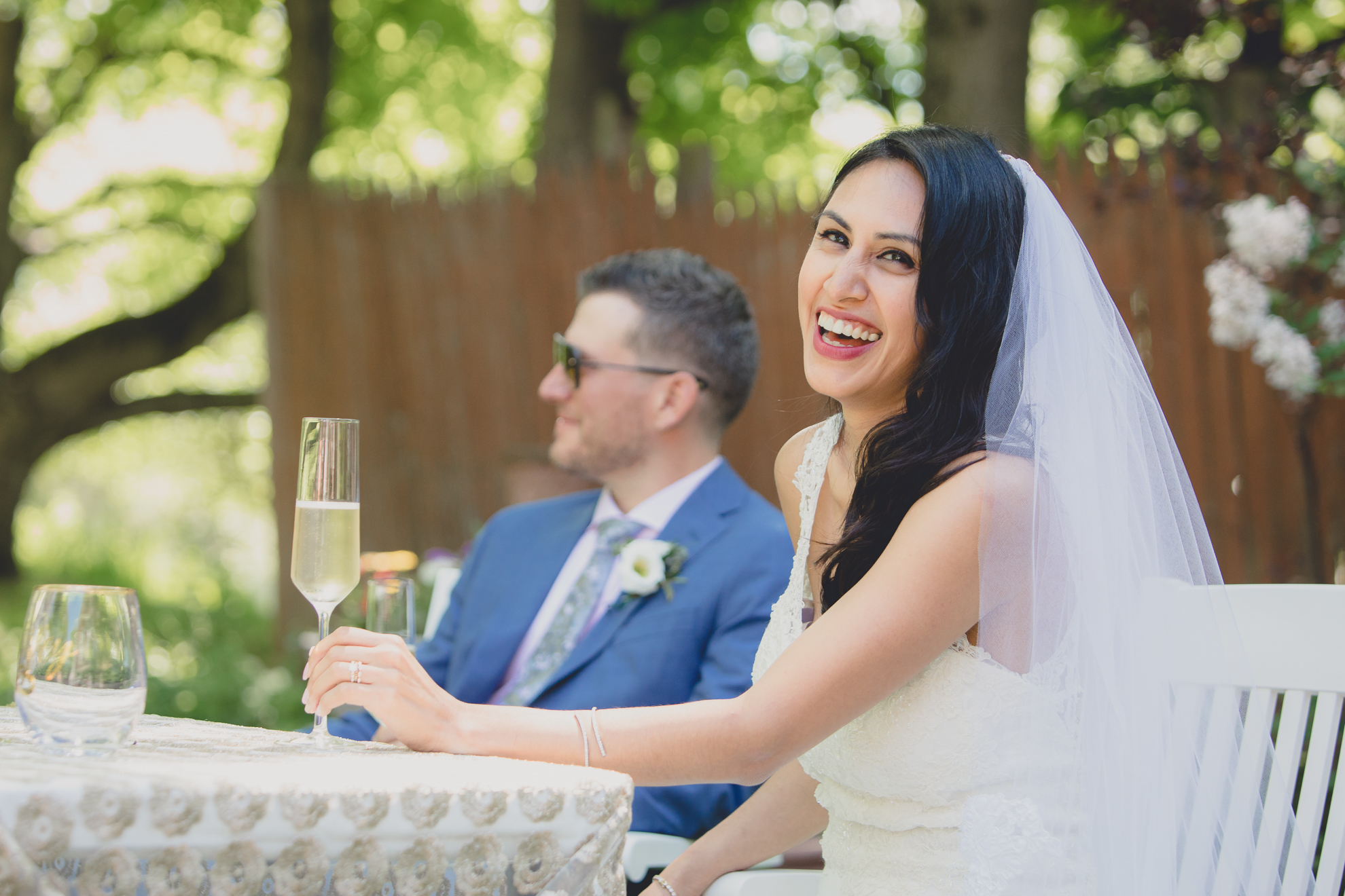 bride laughs at speech during small backyard intimate wedding reception in Buffalo, NY