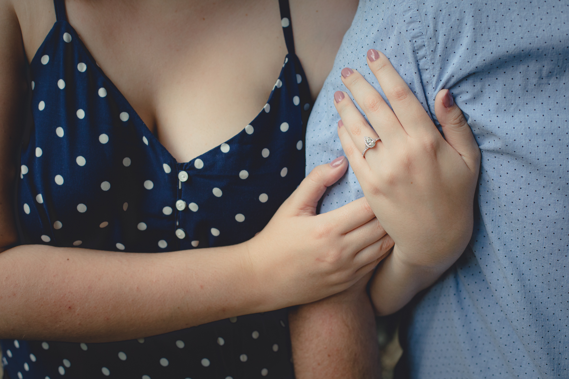 engaged couple shows off engagement ring during their wedding engagement photography session at Akron Falls Park near Buffalo, NY