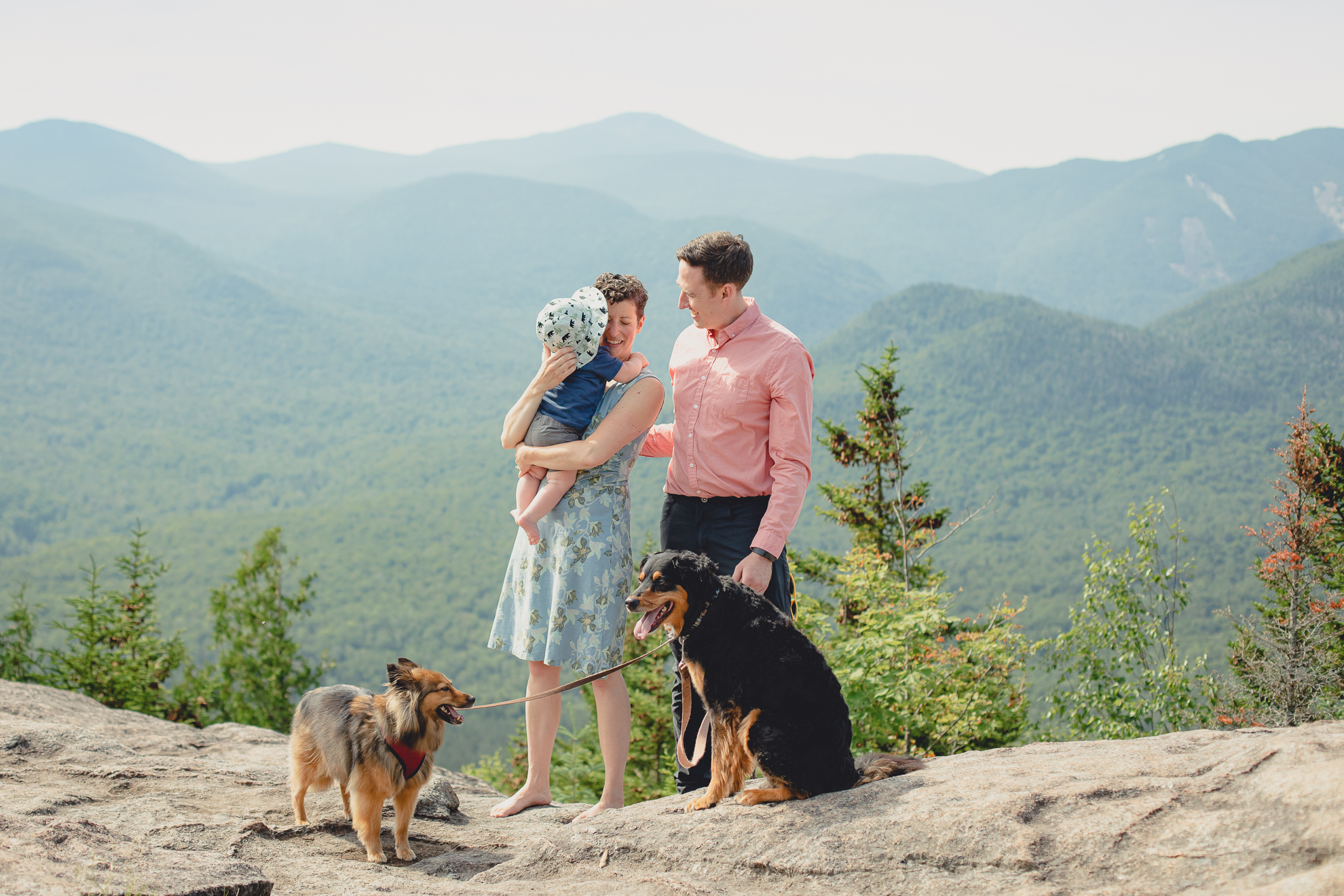 candid family portrait on summit of Mount Jo during photojournalistic family photography session in the Adirondack High Peaks Region of NY
