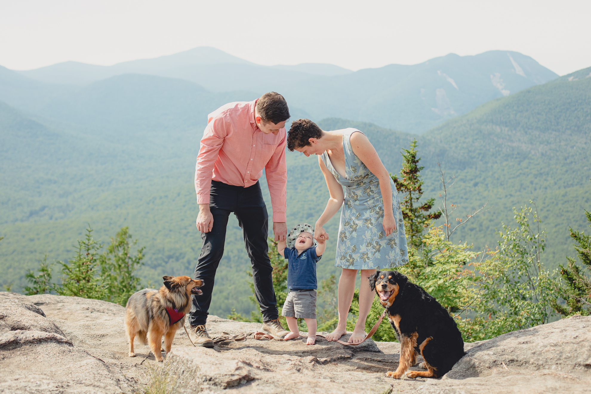 candid family portrait on summit of Mount Jo during photojournalistic family photography session in the Adirondack High Peaks Region of NY