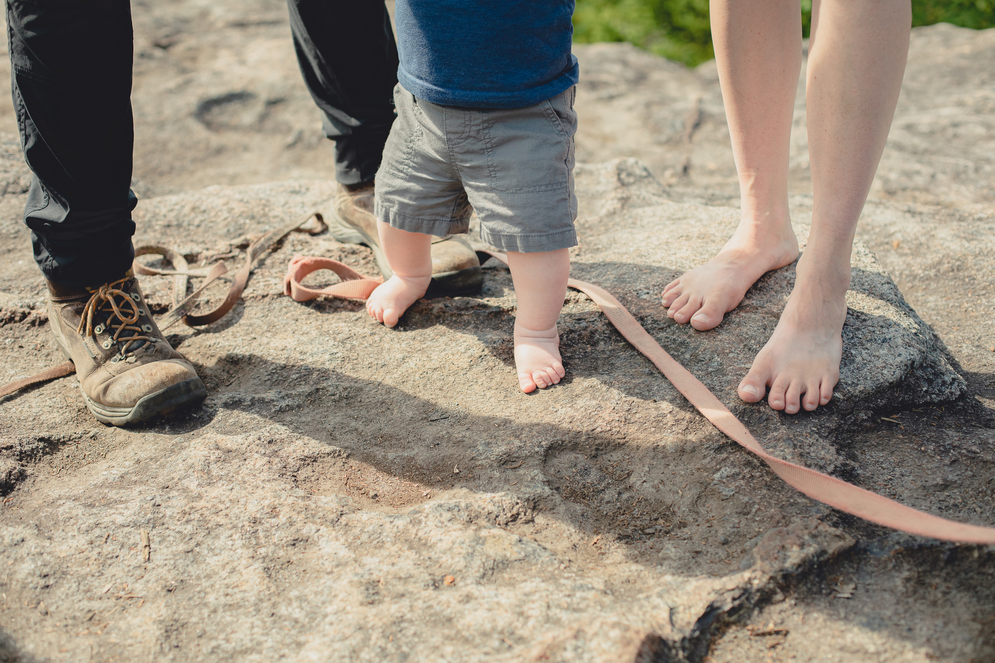 feet during family portrait on summit of Mount Jo during photojournalistic family photography session in the Adirondack High Peaks Region of NY