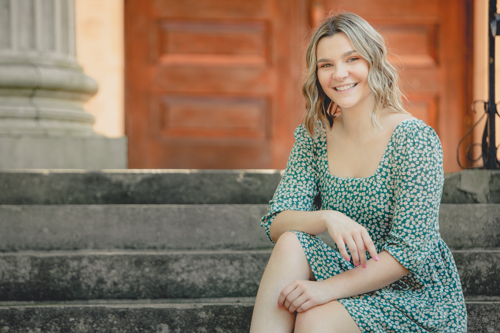 maple grove high school student smiles for photographer on steps of alumni hall during senior pictures at Chautauqua Institution