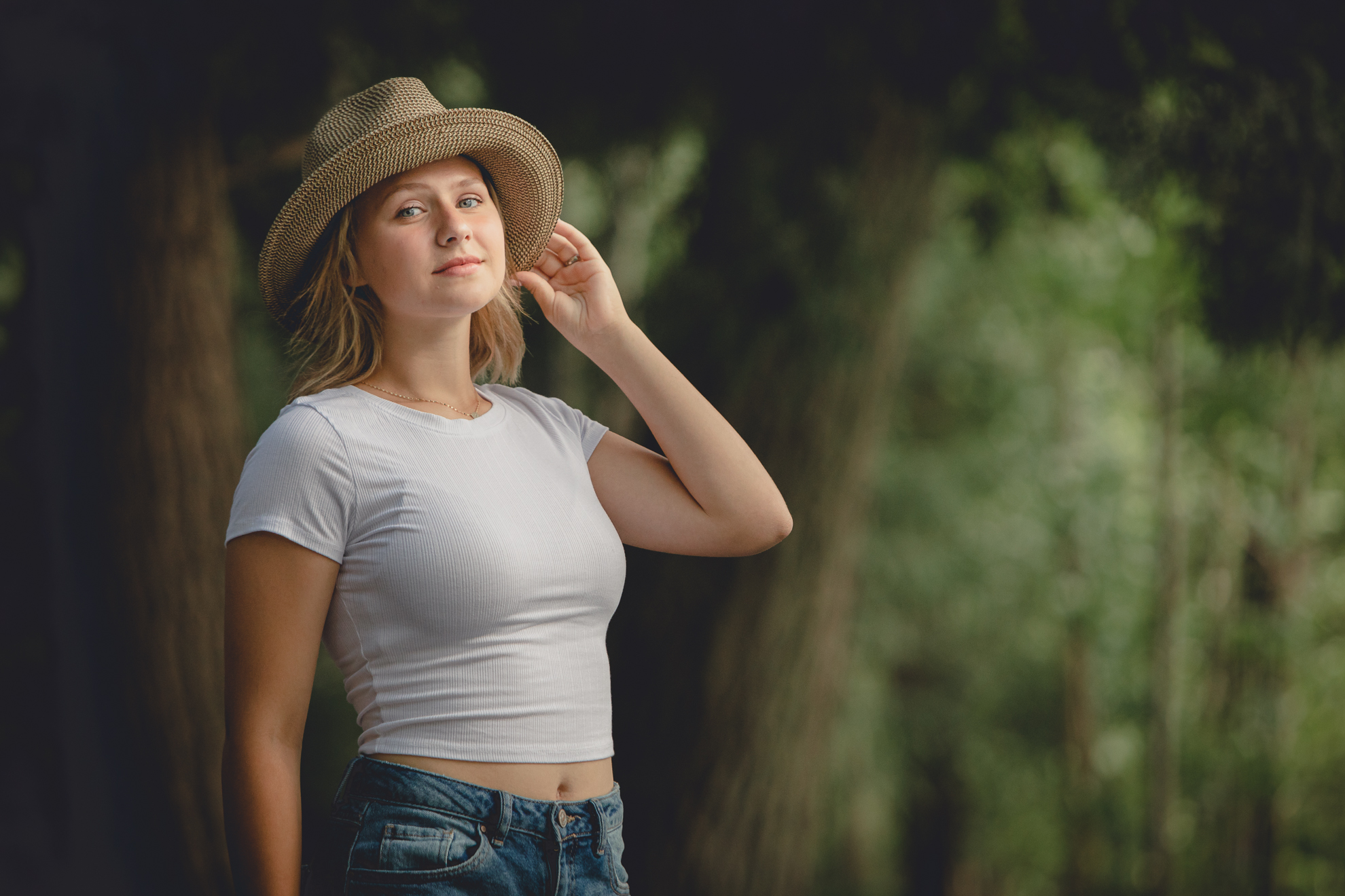WNY senior smiles for photographer during portrait session at Long Point State Park on Lake Chautauqua in Bemus Point, NY