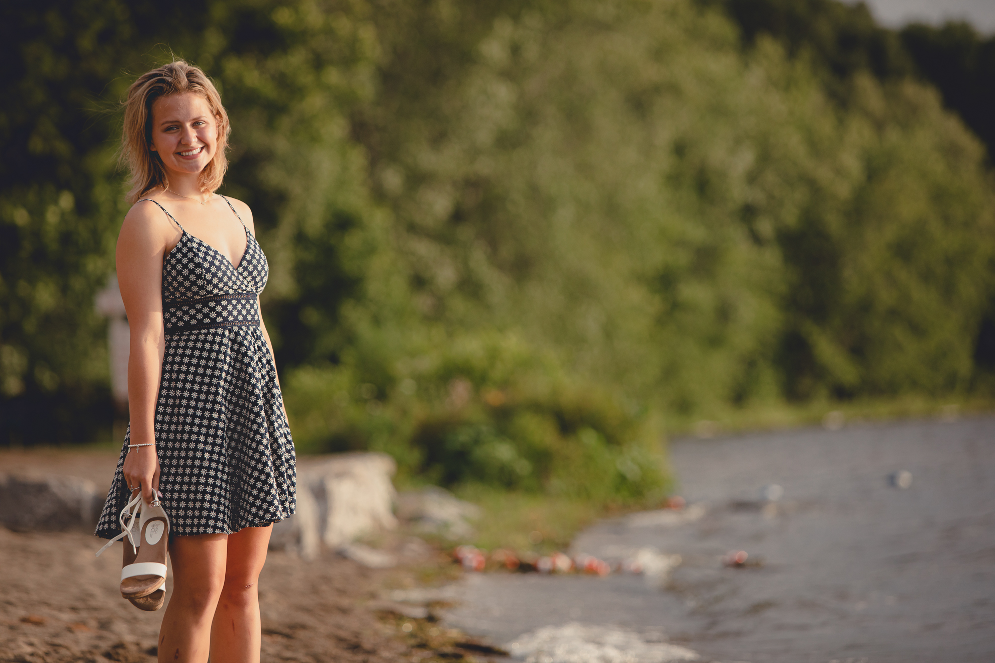 WNY senior smiles for photographer during portrait session at Long Point State Park on Lake Chautauqua in Bemus Point, NY