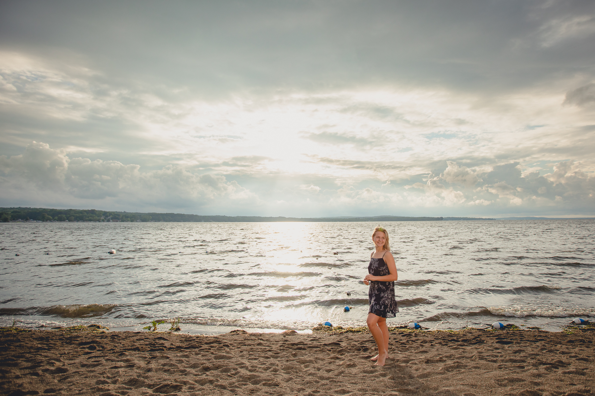 WNY senior smiles during portrait session at Long Point State Park on Lake Chautauqua in Bemus Point, NY