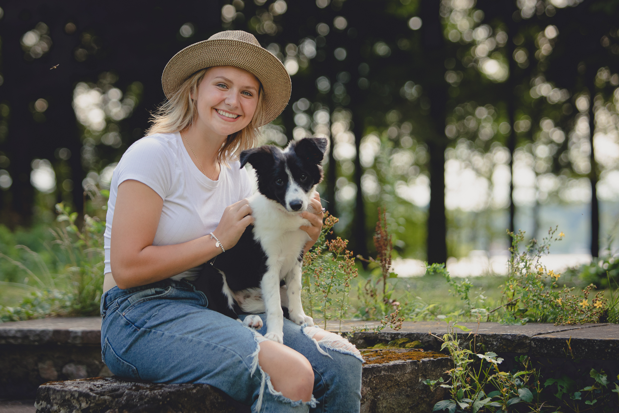 WNY senior and her boarder collie puppy dog smile for photographer during portrait session at Long Point State Park on Lake Chautauqua in Bemus Point, NY