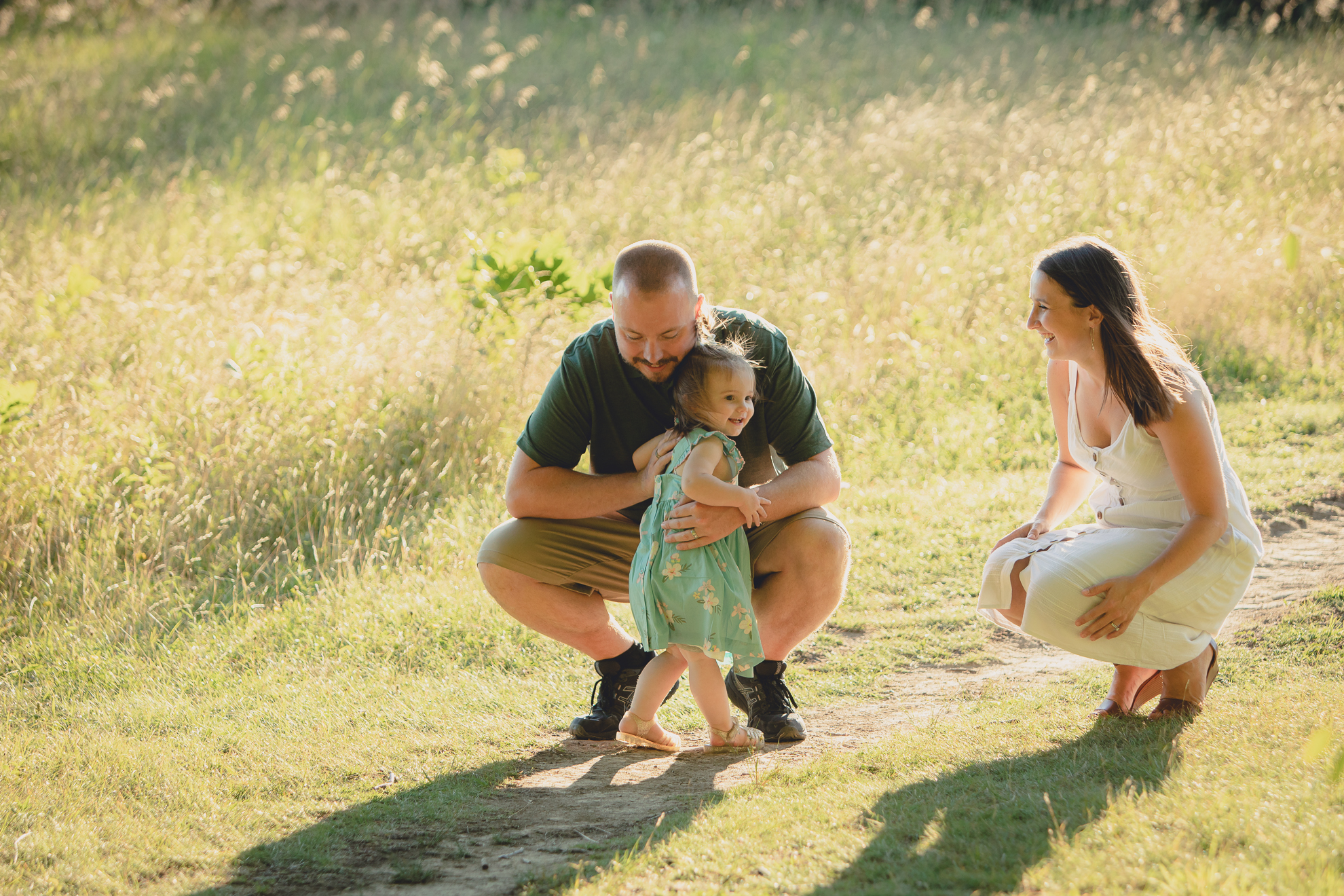 father hugs daughter during family portrait photography session at Knox Farm in East Aurora, a small town near Buffalo