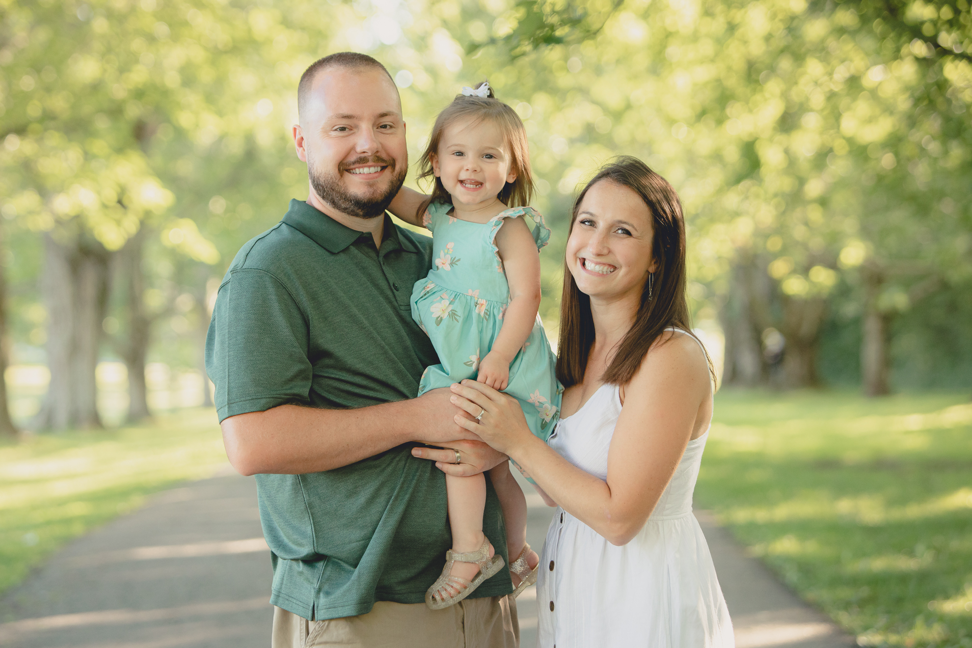 family smiles for photographer during family portrait photography session at Knox Farm in East Aurora, a small town near Buffalo