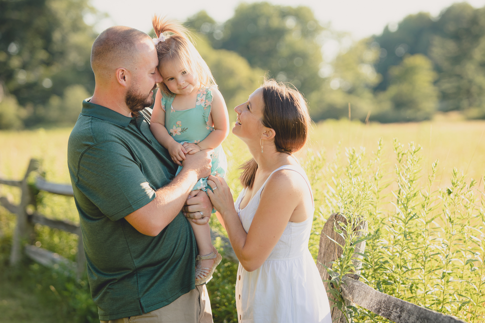 family snuggles during family portrait photography session at Knox Farm in East Aurora, a small town near Buffalo