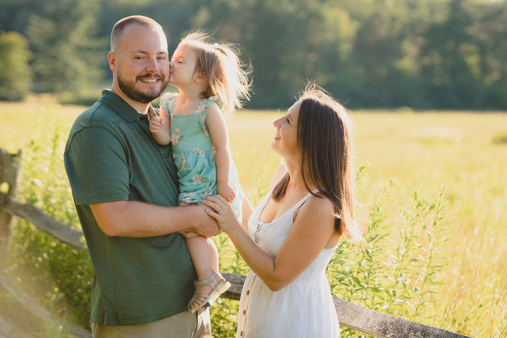 baby kisses father during family portrait photography session at Knox Farm in East Aurora, a small town near Buffalo