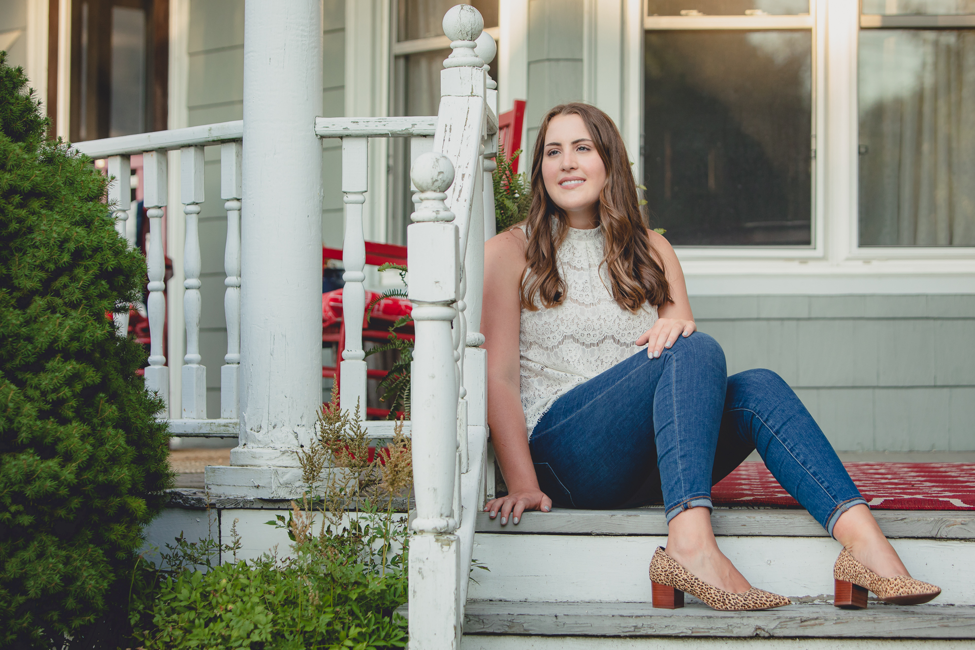 Tessa sits on deck steps during her senior portrait photography session in WNY