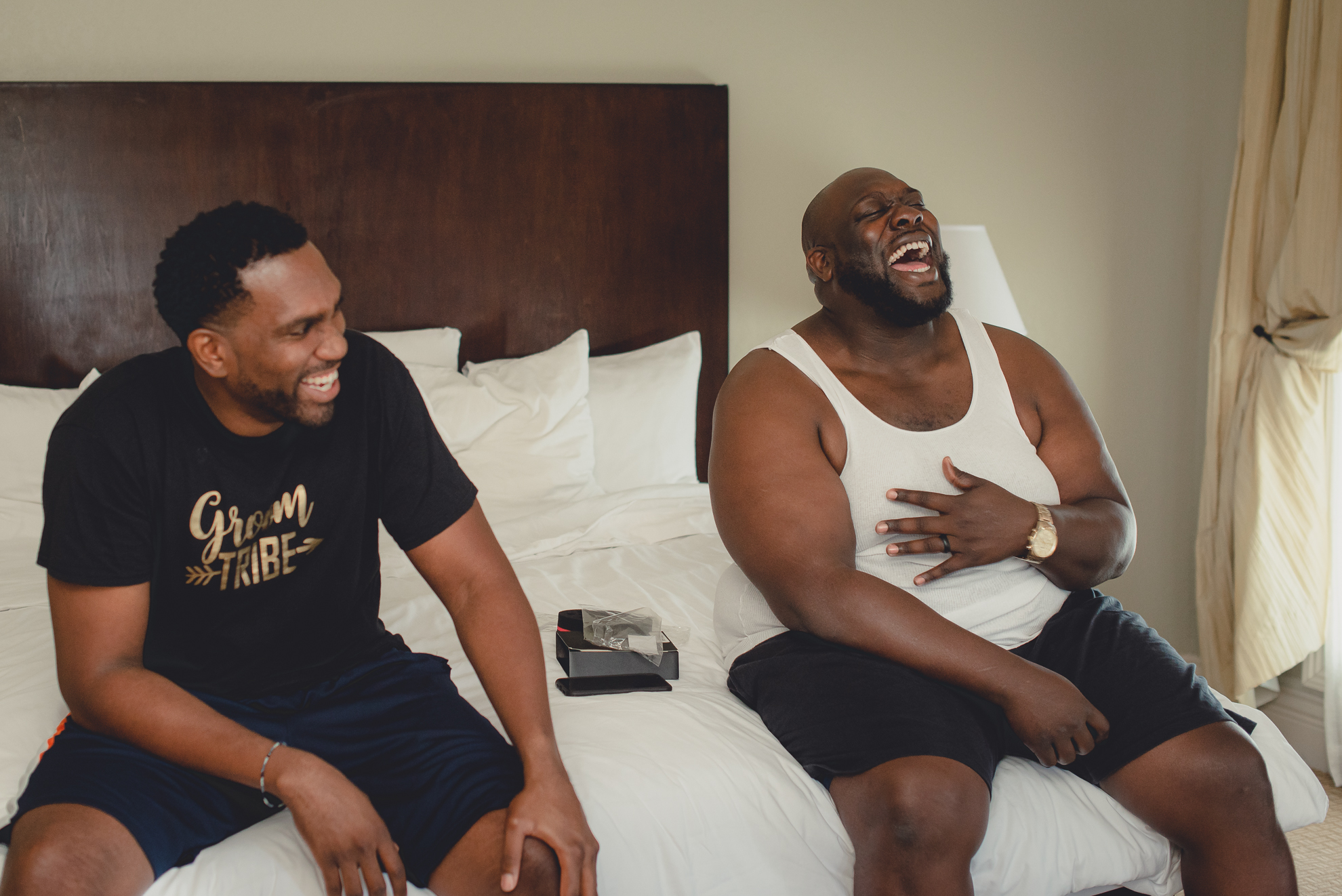 groomsman laugh as they prepare for wedding ceremony at Niagara Crossing Hotel and Spa in Lewiston, NY before micro wedding in WNY