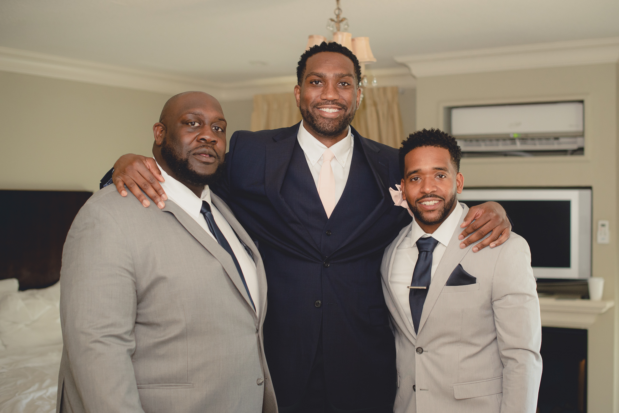 groom and groomsmen smile for photographer before wedding ceremony at Niagara Crossing Hotel and Spa in Lewiston, NY before micro wedding in WNY