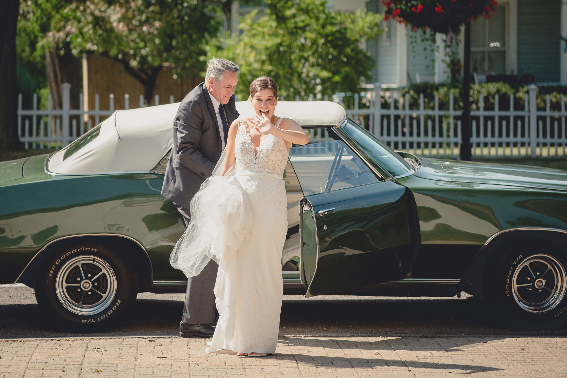 father escorts bride out of vintage Buick before micro wedding ceremony in Lewiston, NY